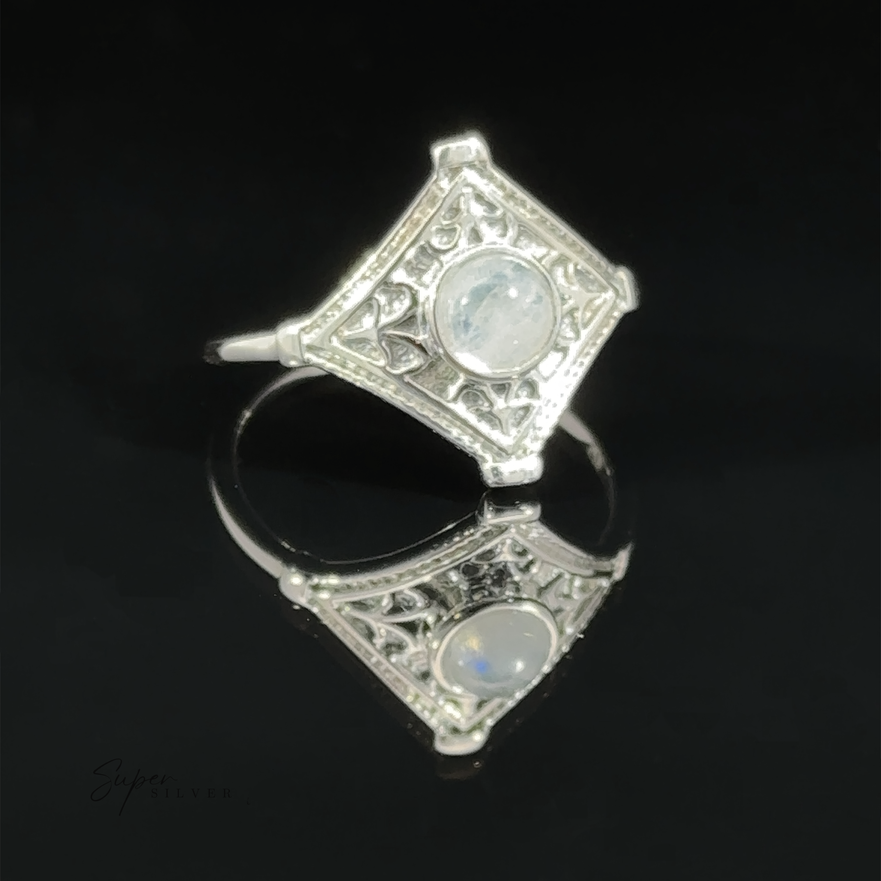 Intricate Diamond Silver Ring with a Round Gemstone crafted on a reflective black surface.