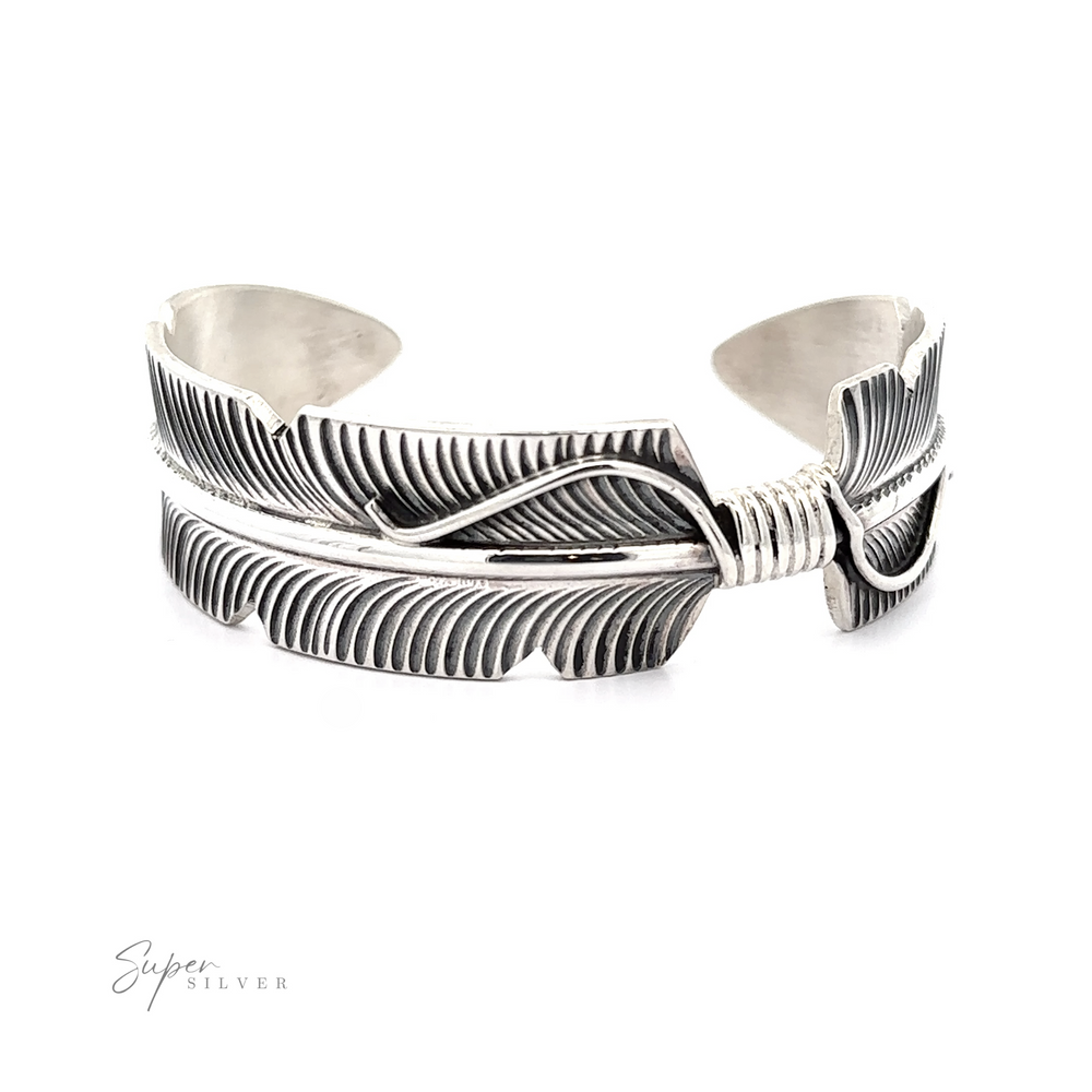 Native American Silver Feather Cuff Bracelet featuring Jewelry craftsmanship with feather design and wrapped wire detail, presented on a white background.