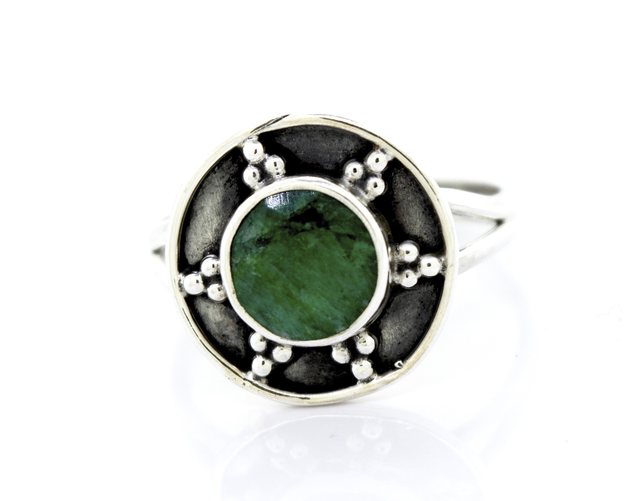 Close-up of a Gemstone Ring With Unique Oxidized Design, featuring a round green gemstone at the center, surrounded by small metal beads.