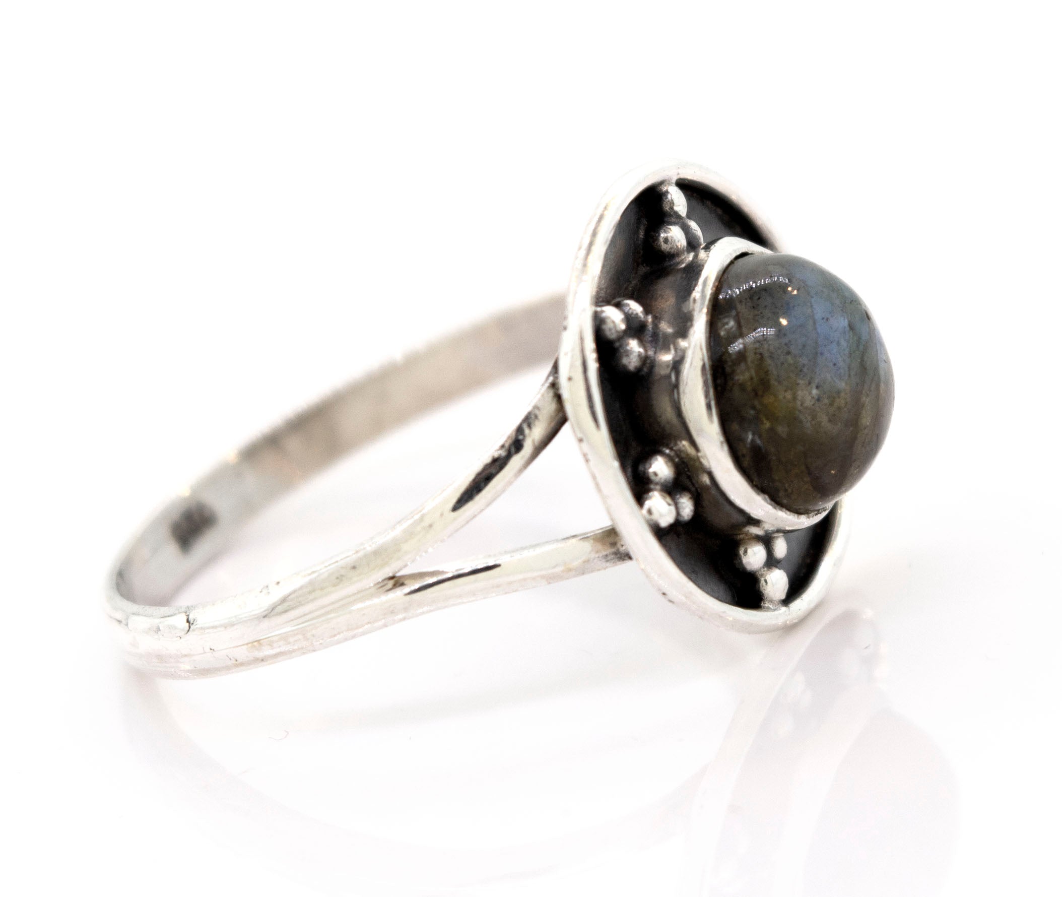 A Gemstone Ring With Unique Oxidized Design featuring a round, dark gemstone set in a raised circular design with small silver bead accents, exemplifying exquisite gemstone jewelry.
