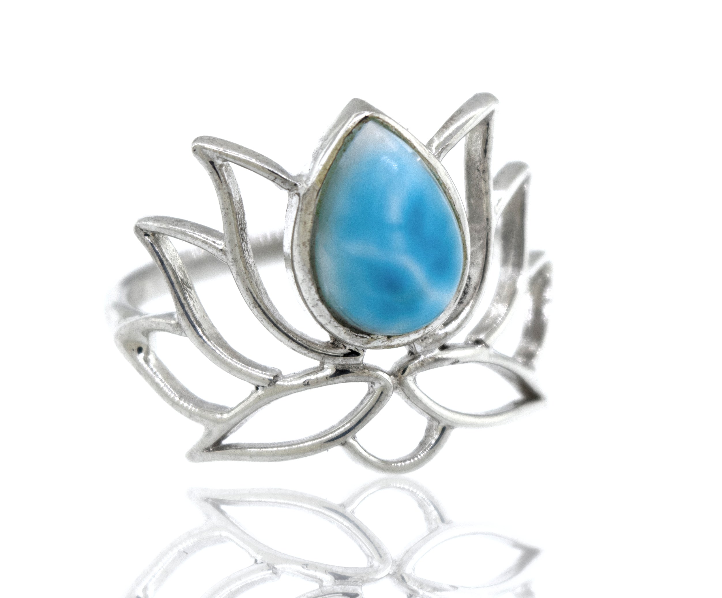 Online Exclusive Teardrop Stone Lotus Ring shaped like a lotus with a blue gemstone in the center, displayed against a white background with reflection.