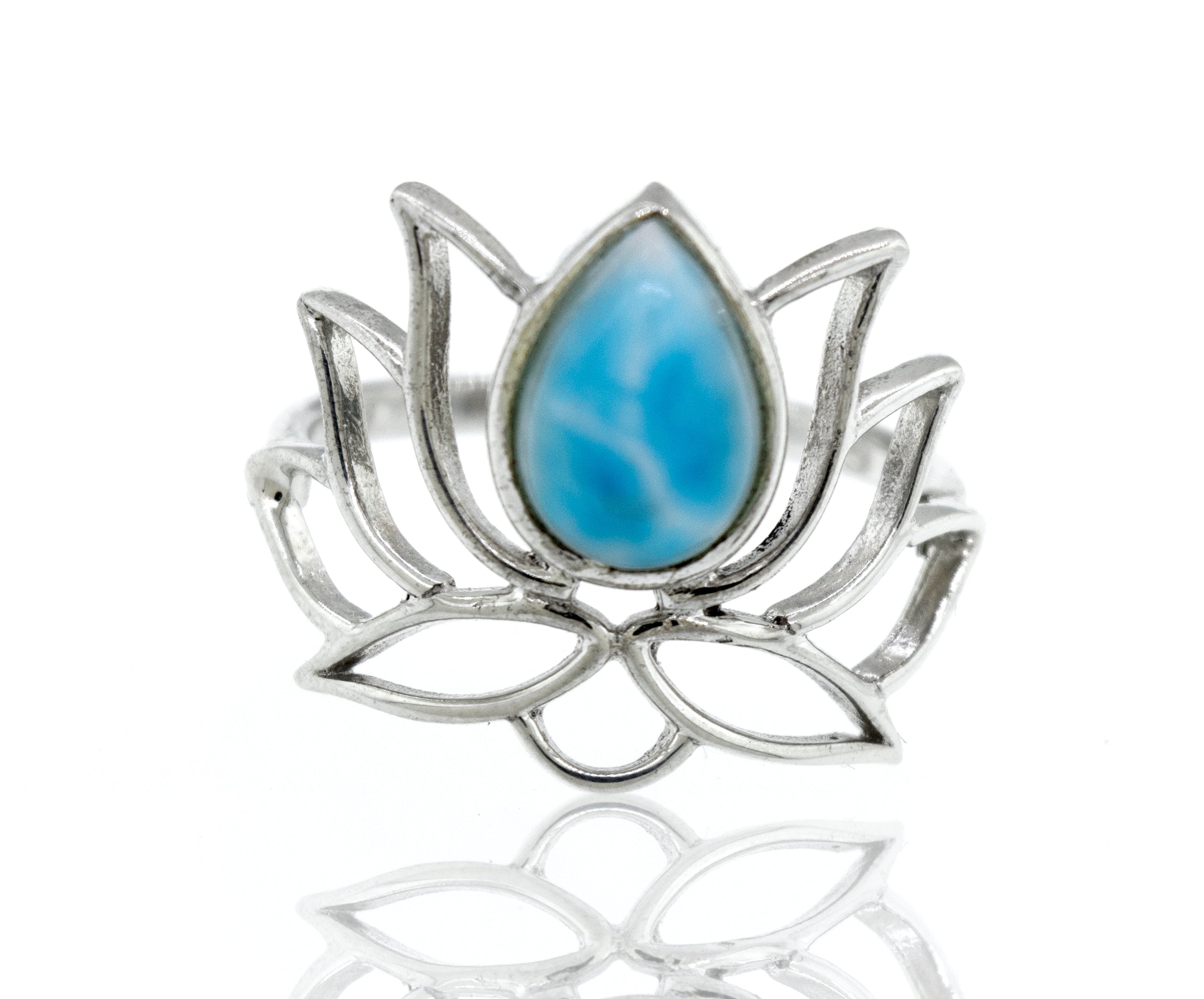 Online Exclusive Teardrop Stone Lotus Ring with a teardrop blue gemstone in the center, on a reflective white surface.