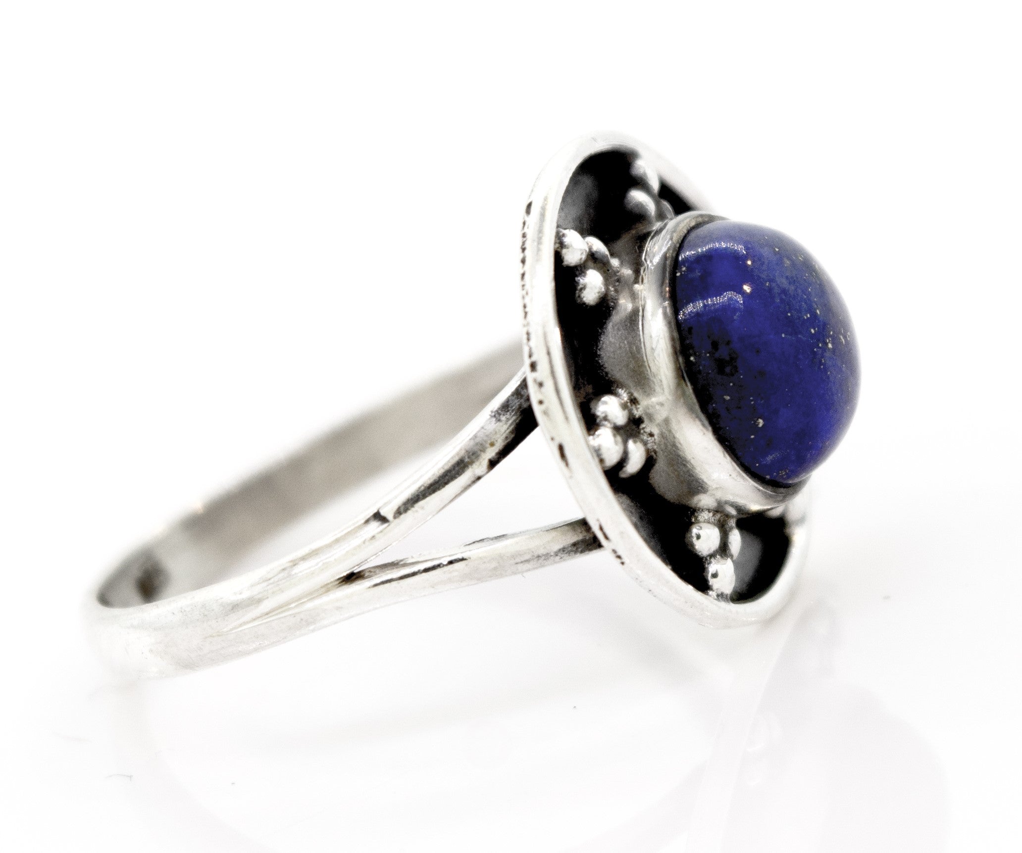 A sterling silver ring with a split shank design features a round blue stone set in a decorative bezel, embodying the essence of the Gemstone Ring With Unique Oxidized Design.