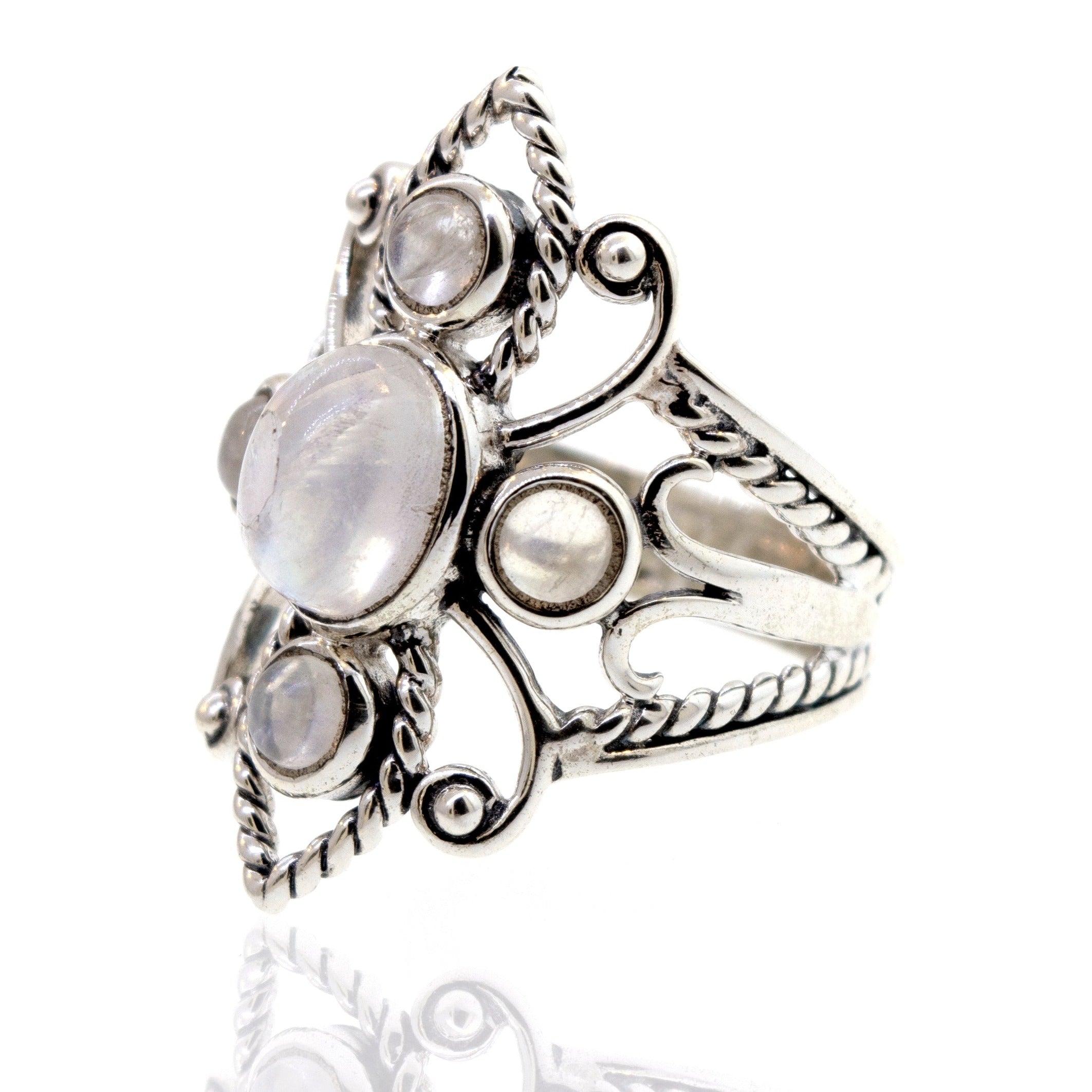 Online Only Exclusive Multistone Ring with multiple moonstones set in an intricate design, displayed against a white background with a reflection below.