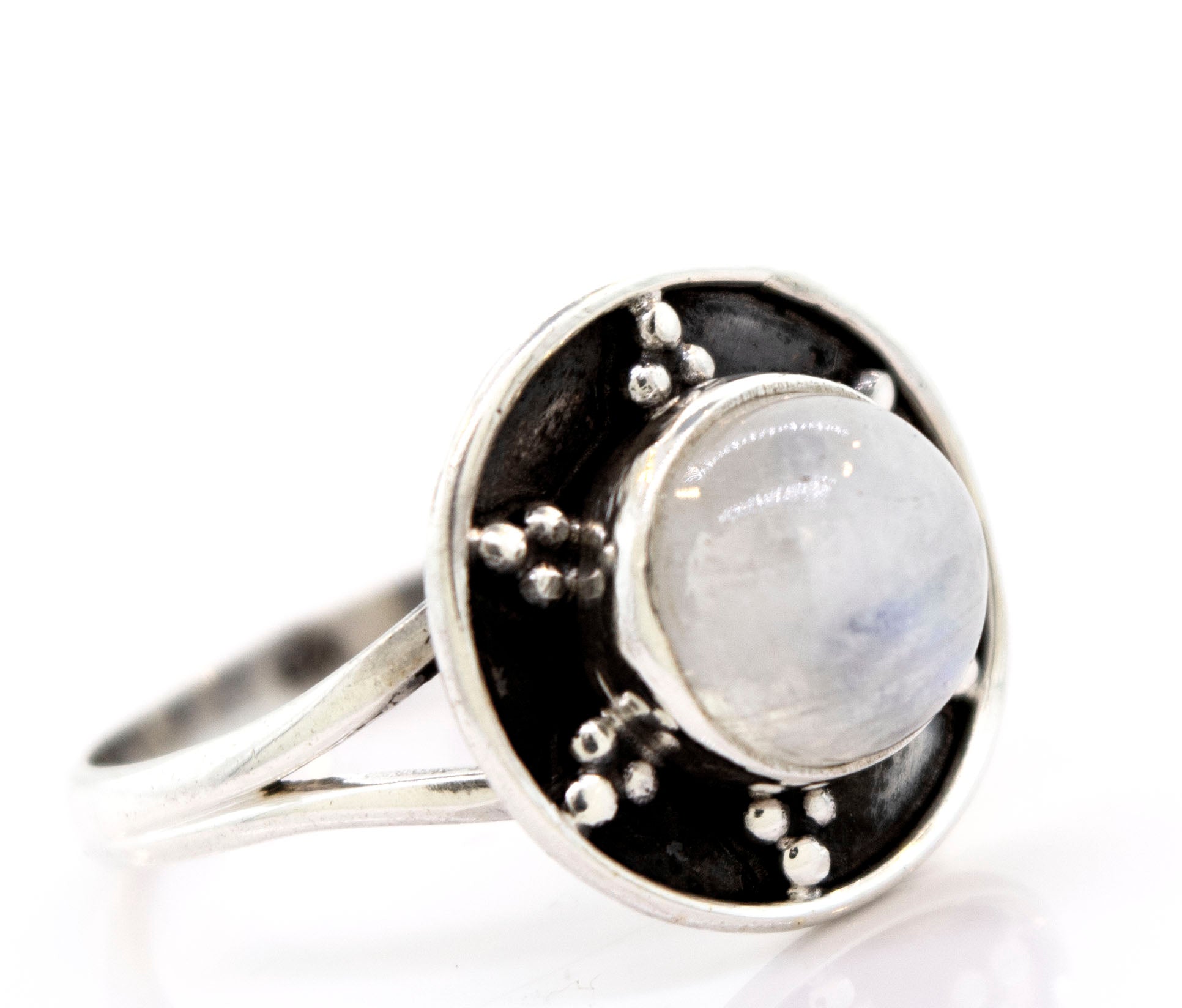 A Gemstone Ring With Unique Oxidized Design featuring a round white gemstone set in an oxidized silver circular setting with small sterling silver bead accents, epitomizing elegant gemstone jewelry.