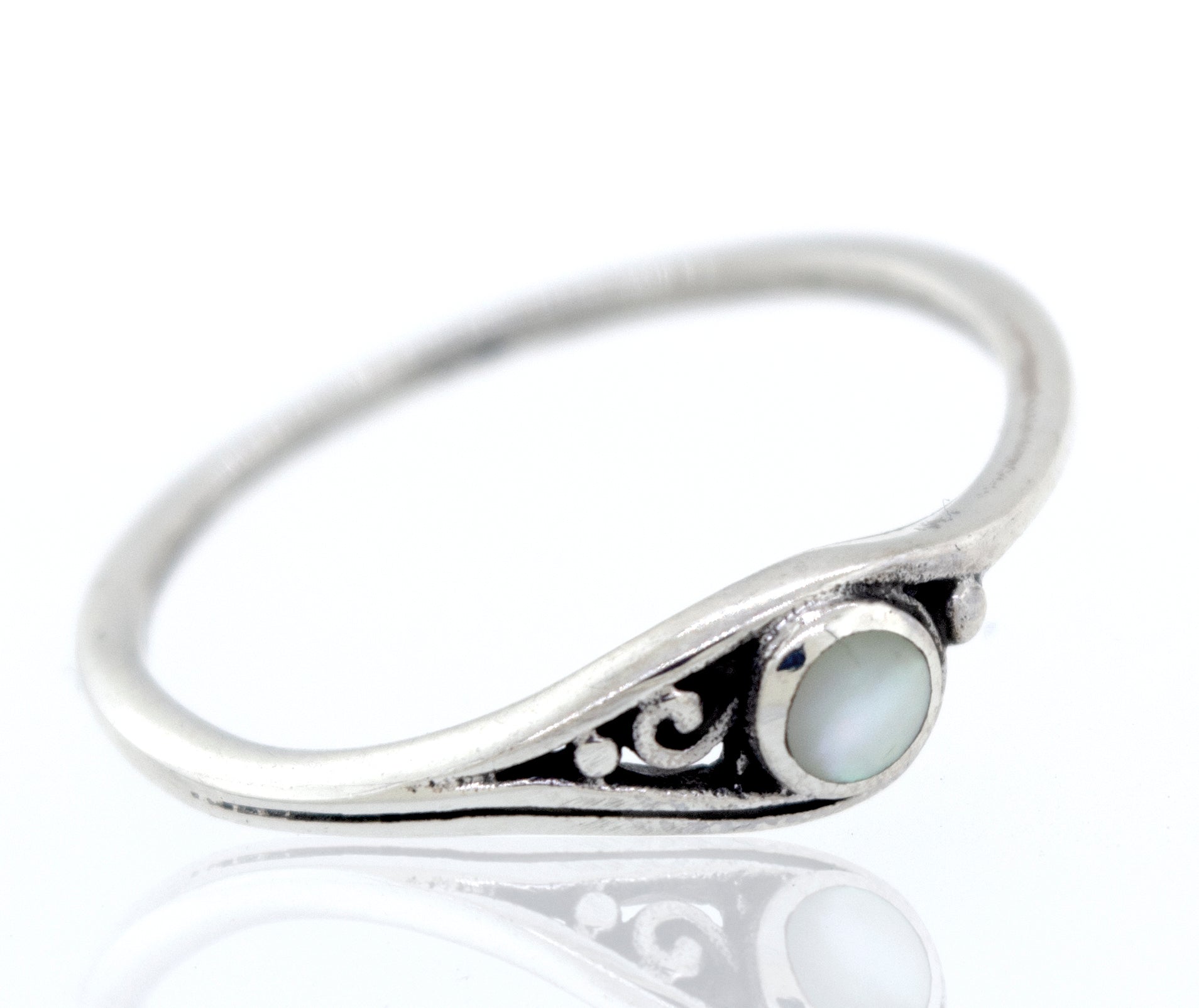 A Delicate Inlay Stone Ring with Small Swirl Design with inlaid mother of pearl.