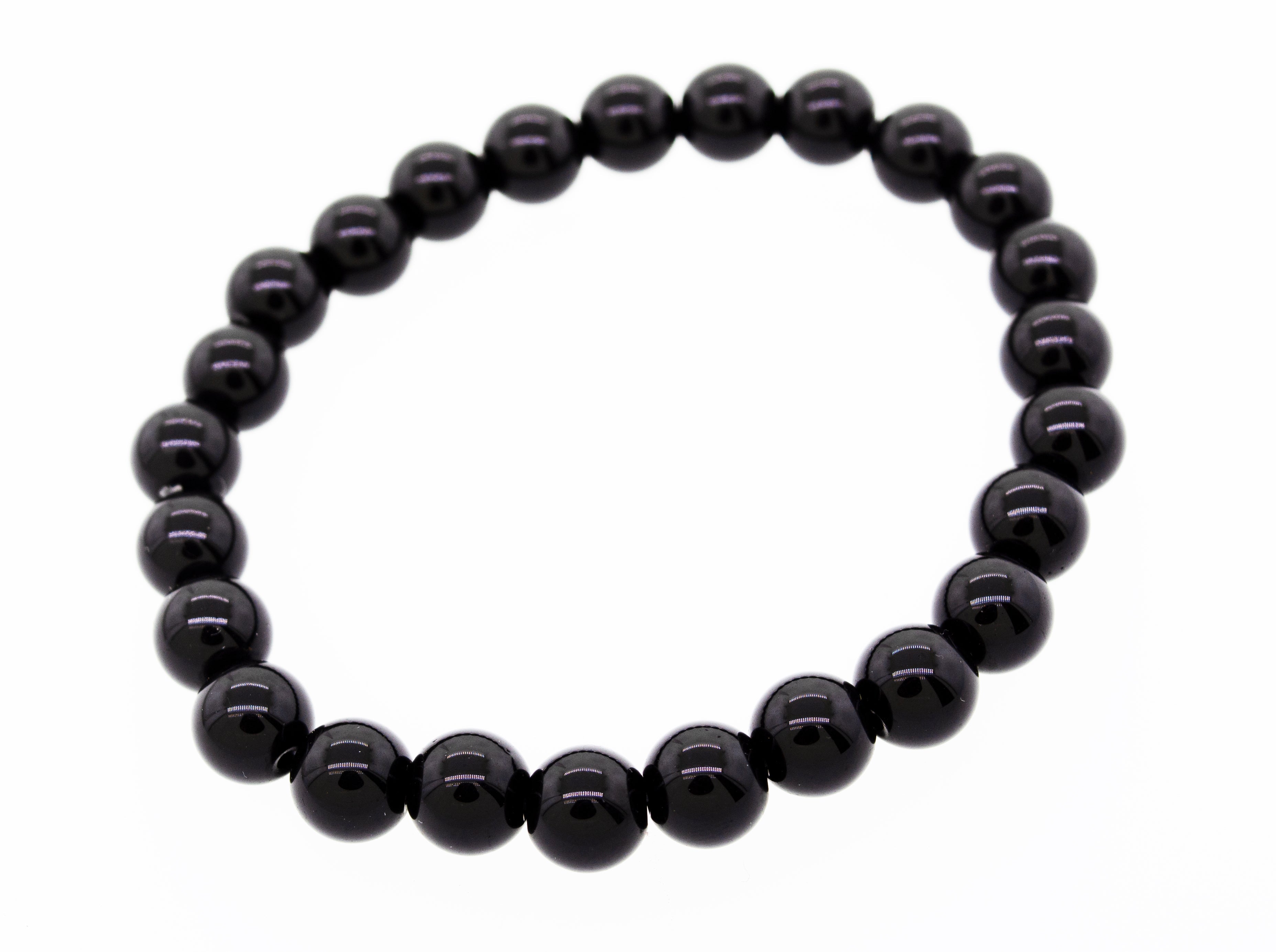 A black 4mm beaded healing stone bracelet arranged in a circle, displayed on a white background.