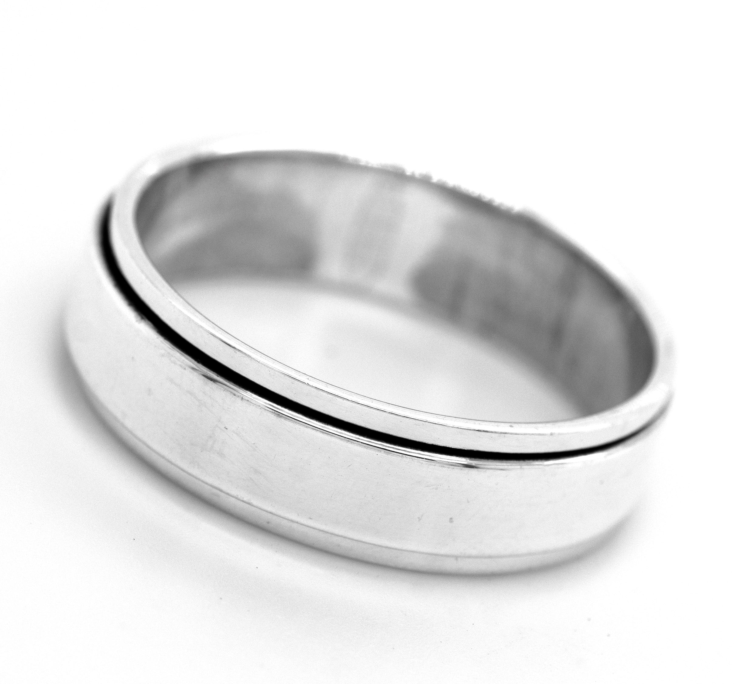 The Simple Silver Spinner Ring is a plain silver anxiety ring featuring a single shallow groove parallel to its edge, displayed on a white background.