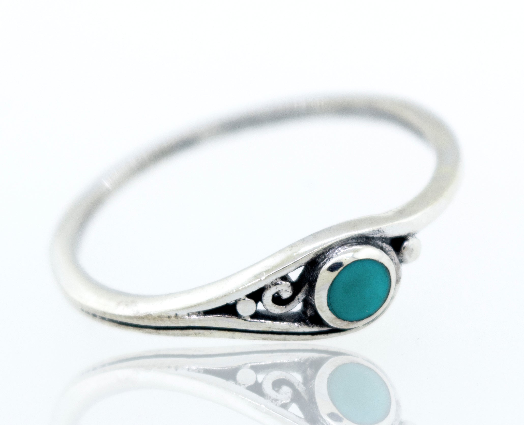 A delicate inlay stone ring with small swirl design made of sterling silver.