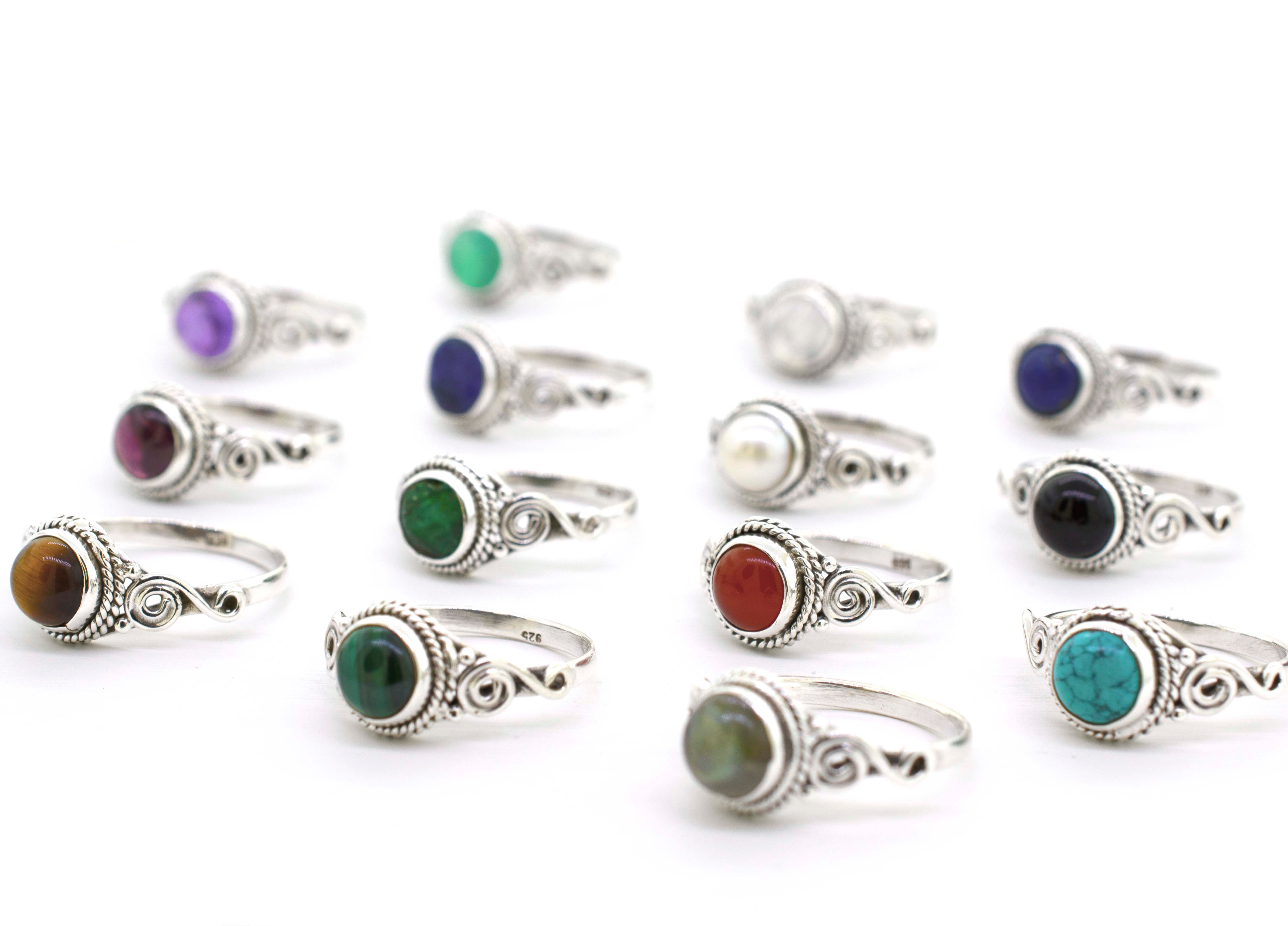 A Gemstone Circle Ring With Rope Border And Swirl Design, perfect for Santa Cruz style.