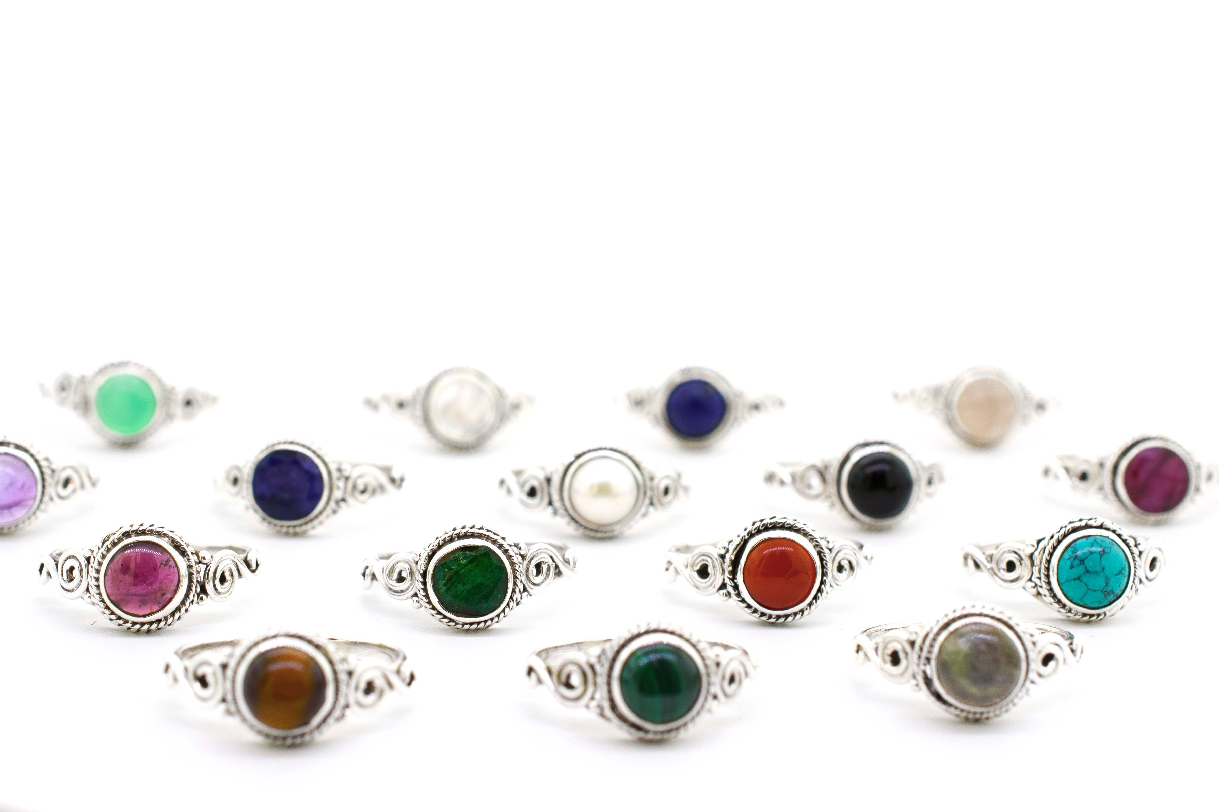 A group of Gemstone Circle Rings With Rope Border And Swirl Design on a sterling silver background.