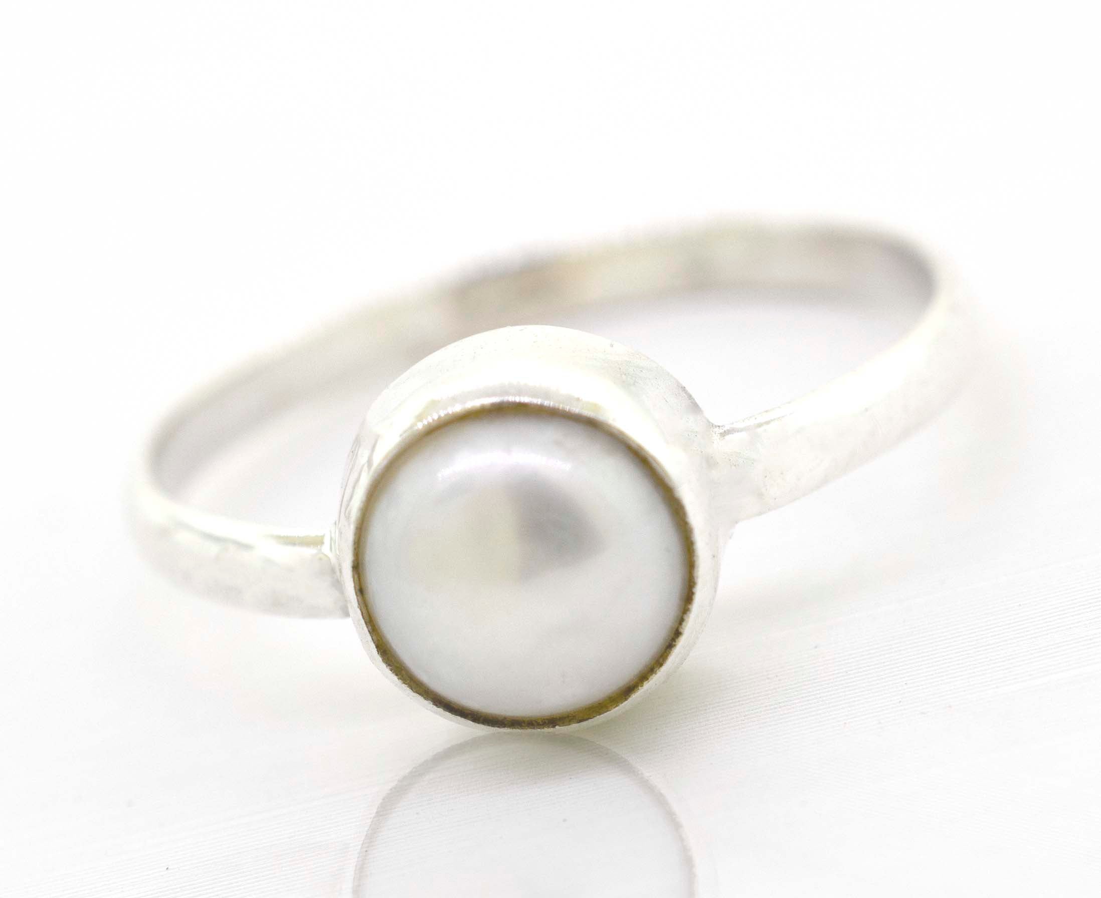A boho-inspired Simple Marquise Shaped Gemstone Ring made of sterling silver, set elegantly on a crisp white surface.