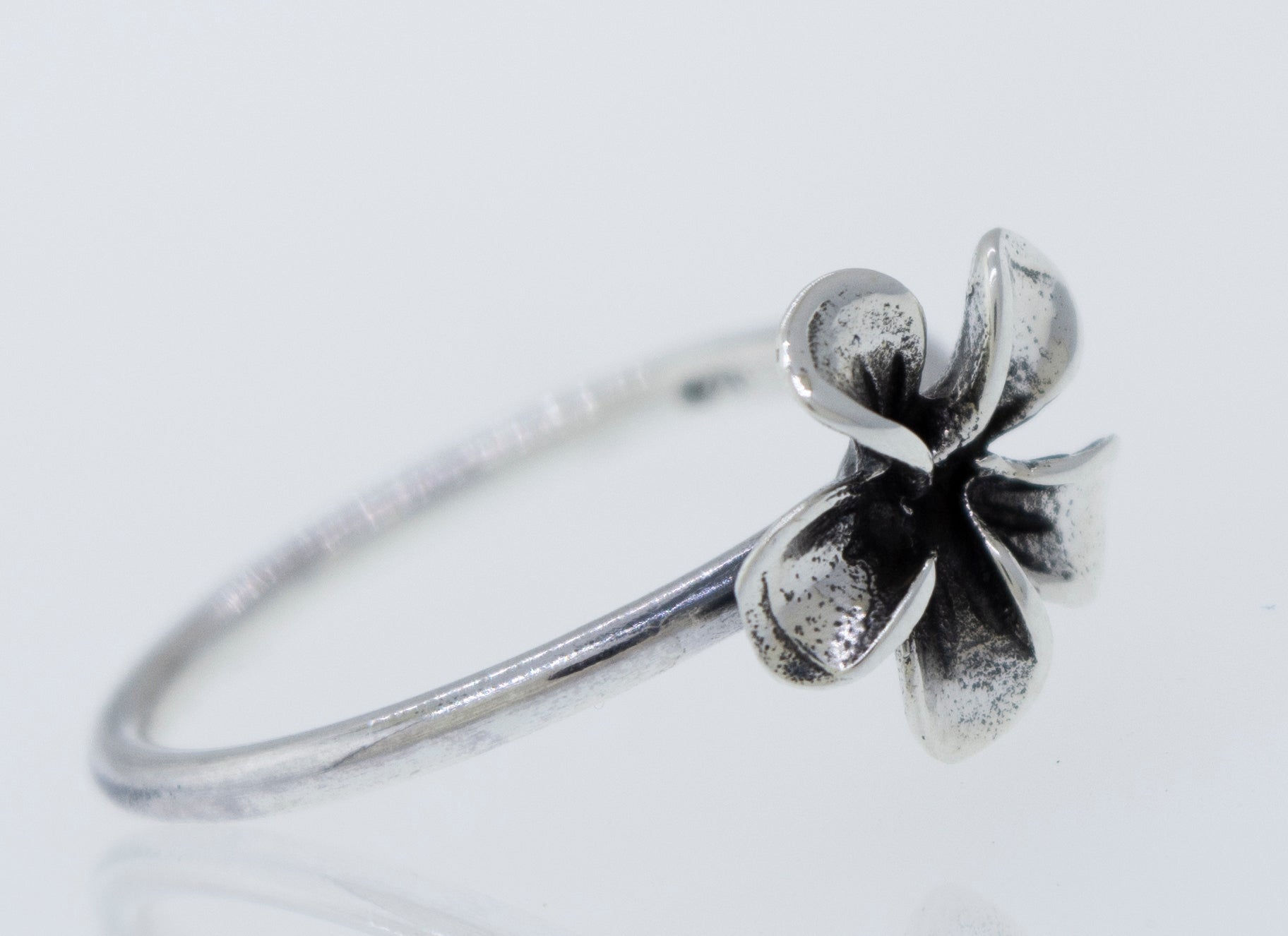 A boho-inspired Plumeria Ring with a delicate flower design, perfect for Santa Cruz beach vibes.