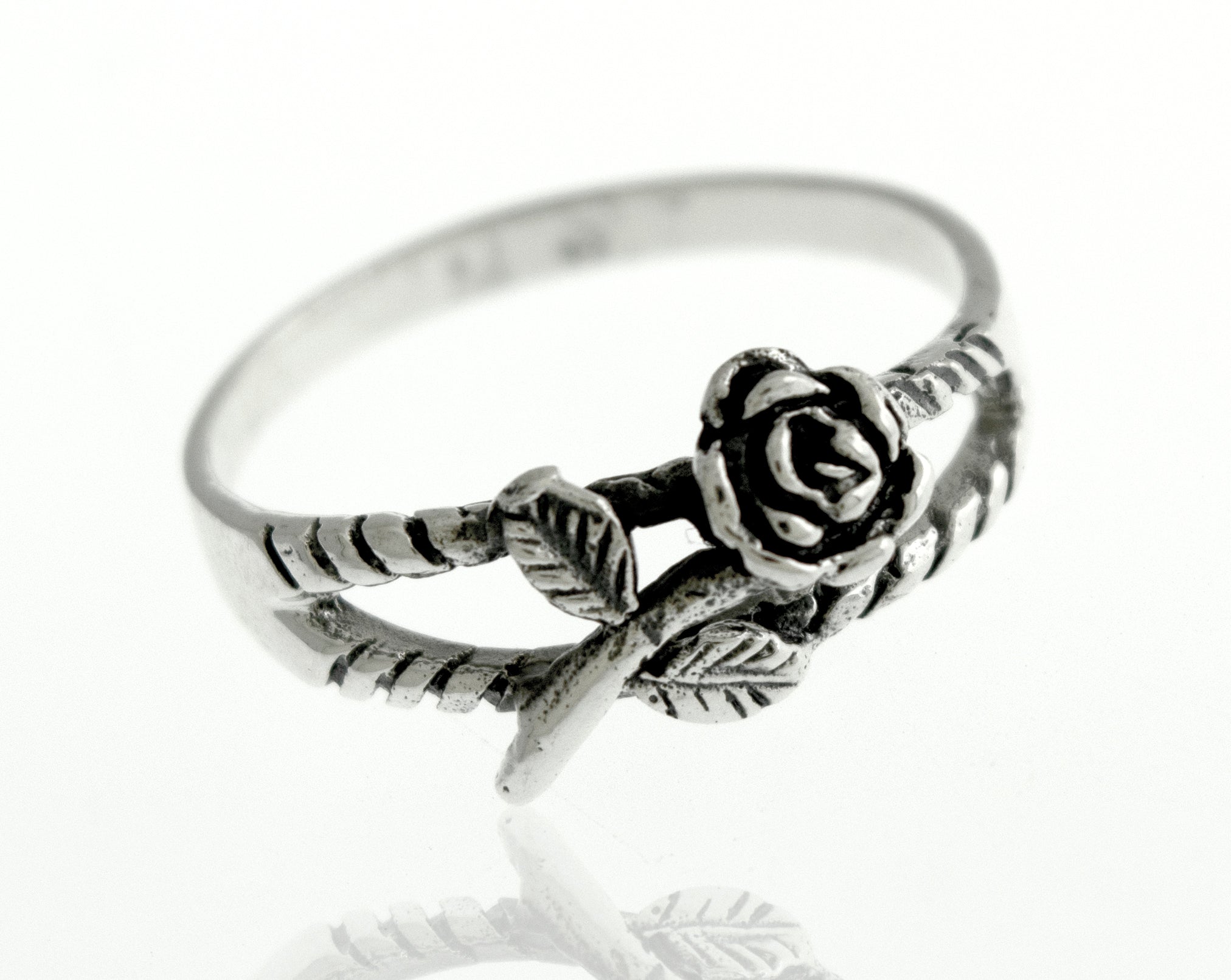 A Sterling Silver Rose Ring adorned with a delicate rose, showcasing its floral charm.