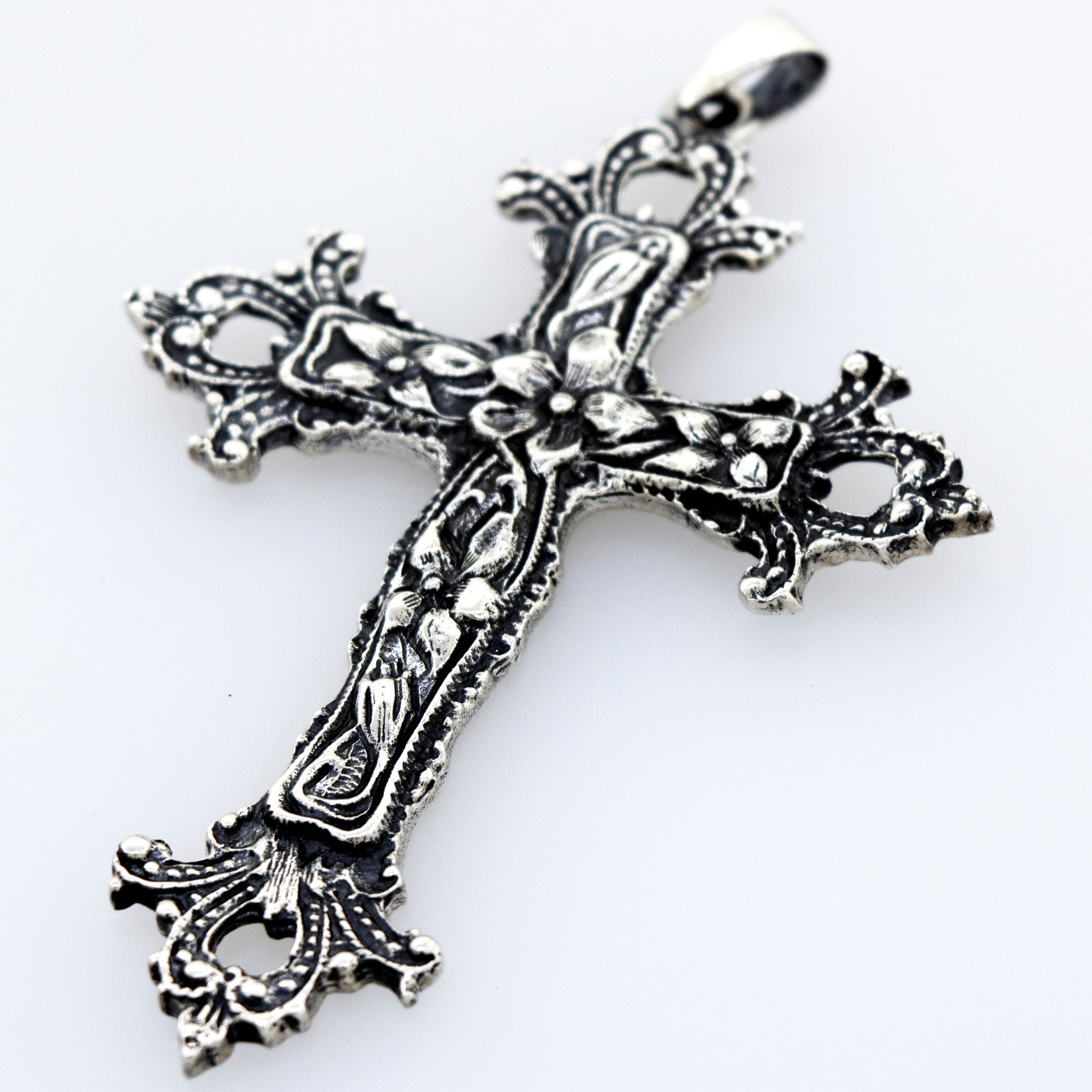 An ornate Medieval Floral Cross Pendant, a statement centerpiece on a white surface by Super Silver.