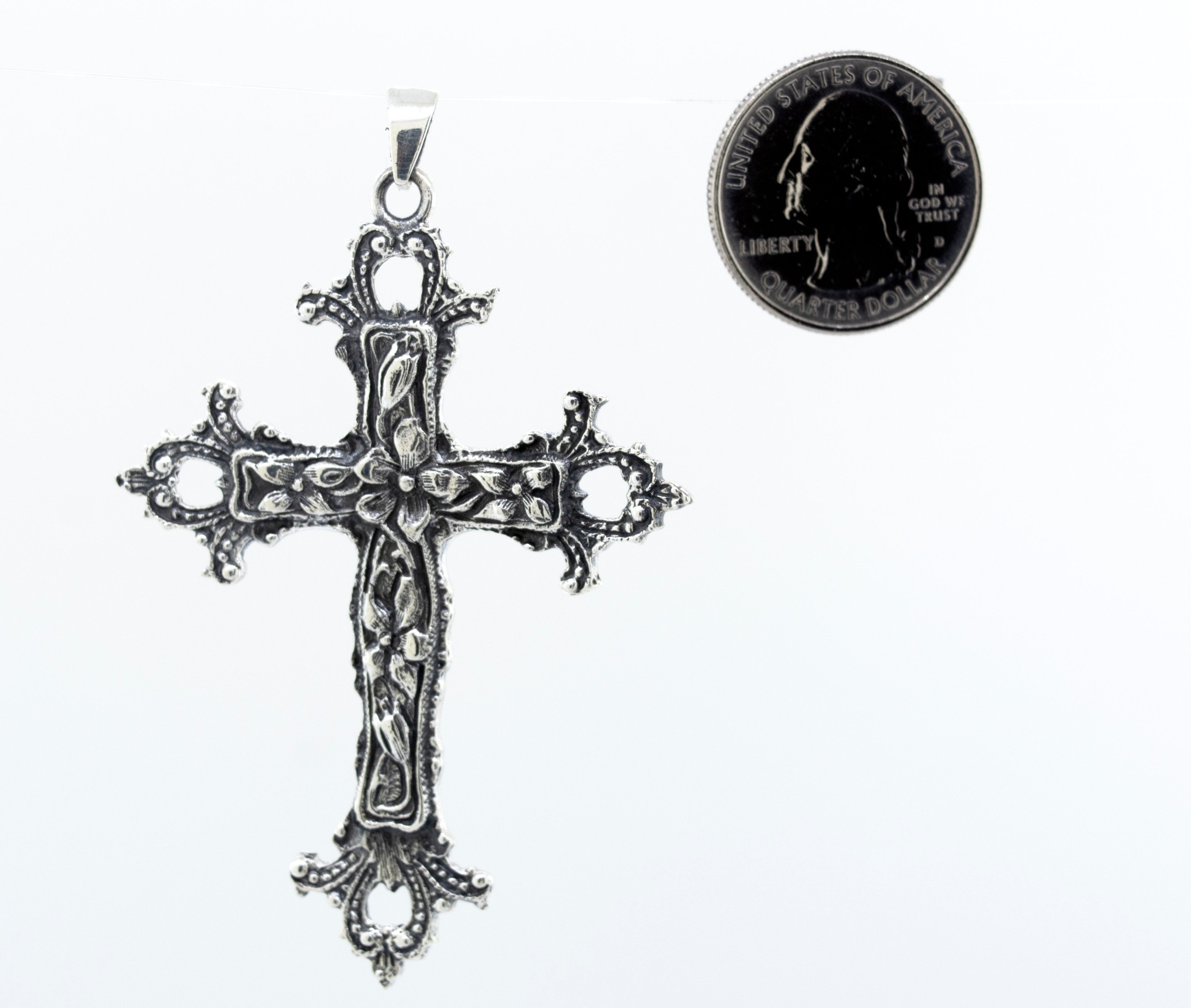 A vintage-style Super Silver Medieval Floral Cross Pendant with a coin, serving as a statement centerpiece.