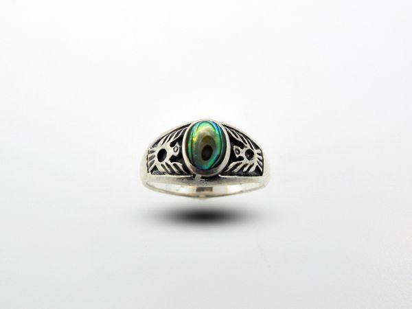 A Native American Inspired Ring With Phoenix Design with a green stone in the middle.