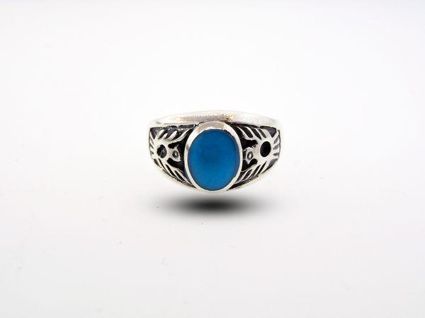 A Native American inspired silver ring with a blue stone.