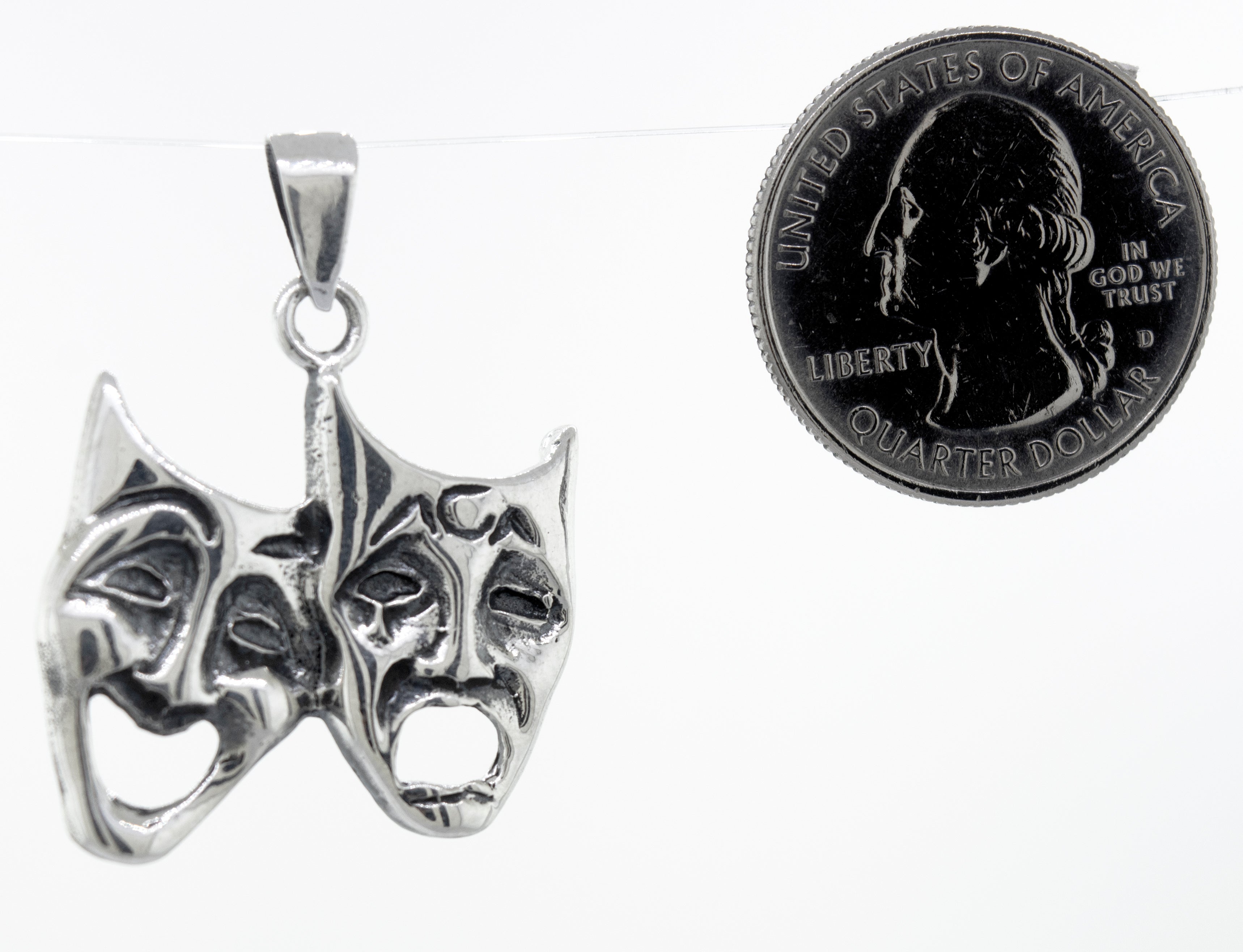 This Laugh Now Cry Later Pendant by Super Silver features two theatre masks.