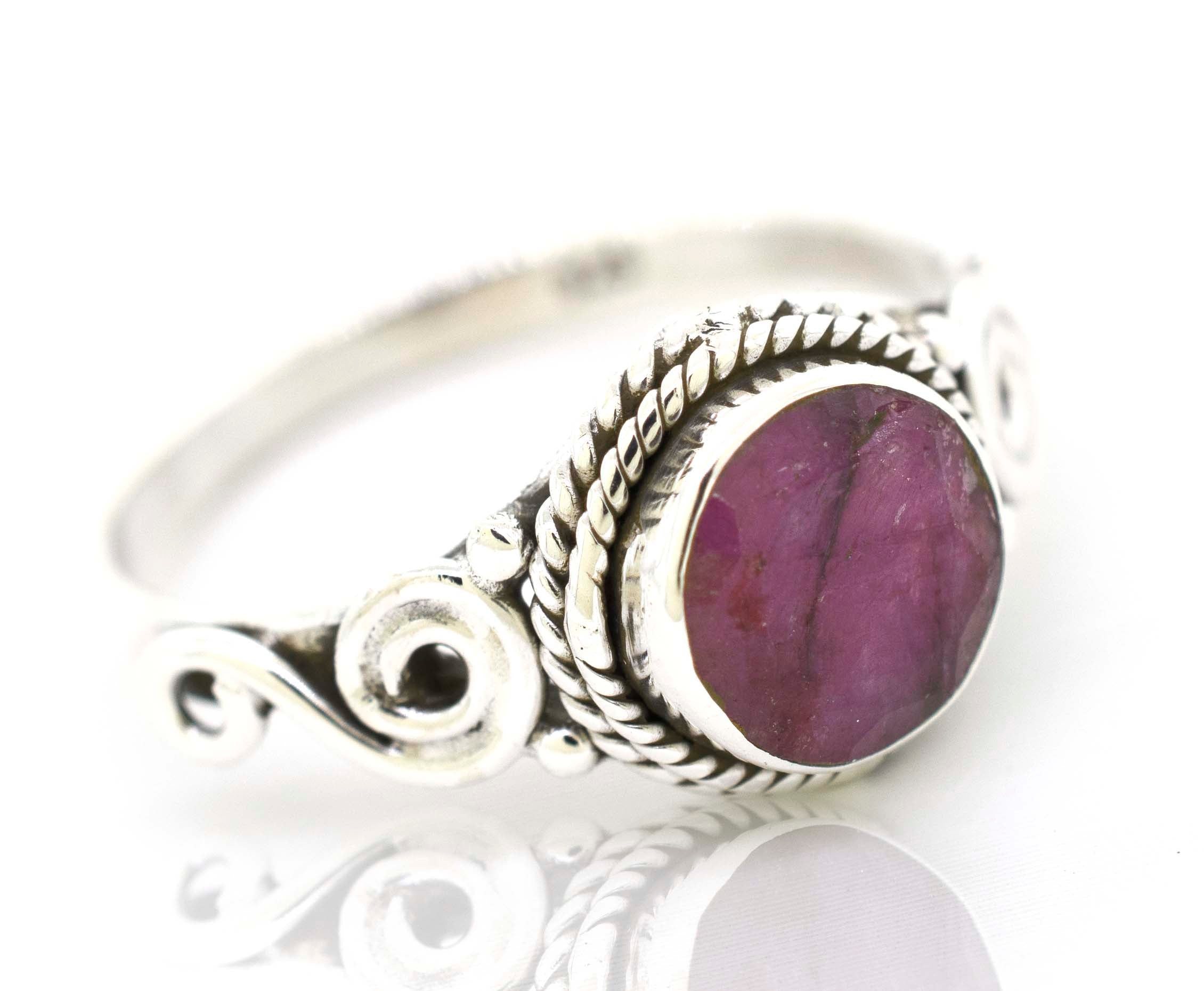 A bohemian-inspired Super Silver Gemstone Circle Ring With Rope Border And Swirl Design.
