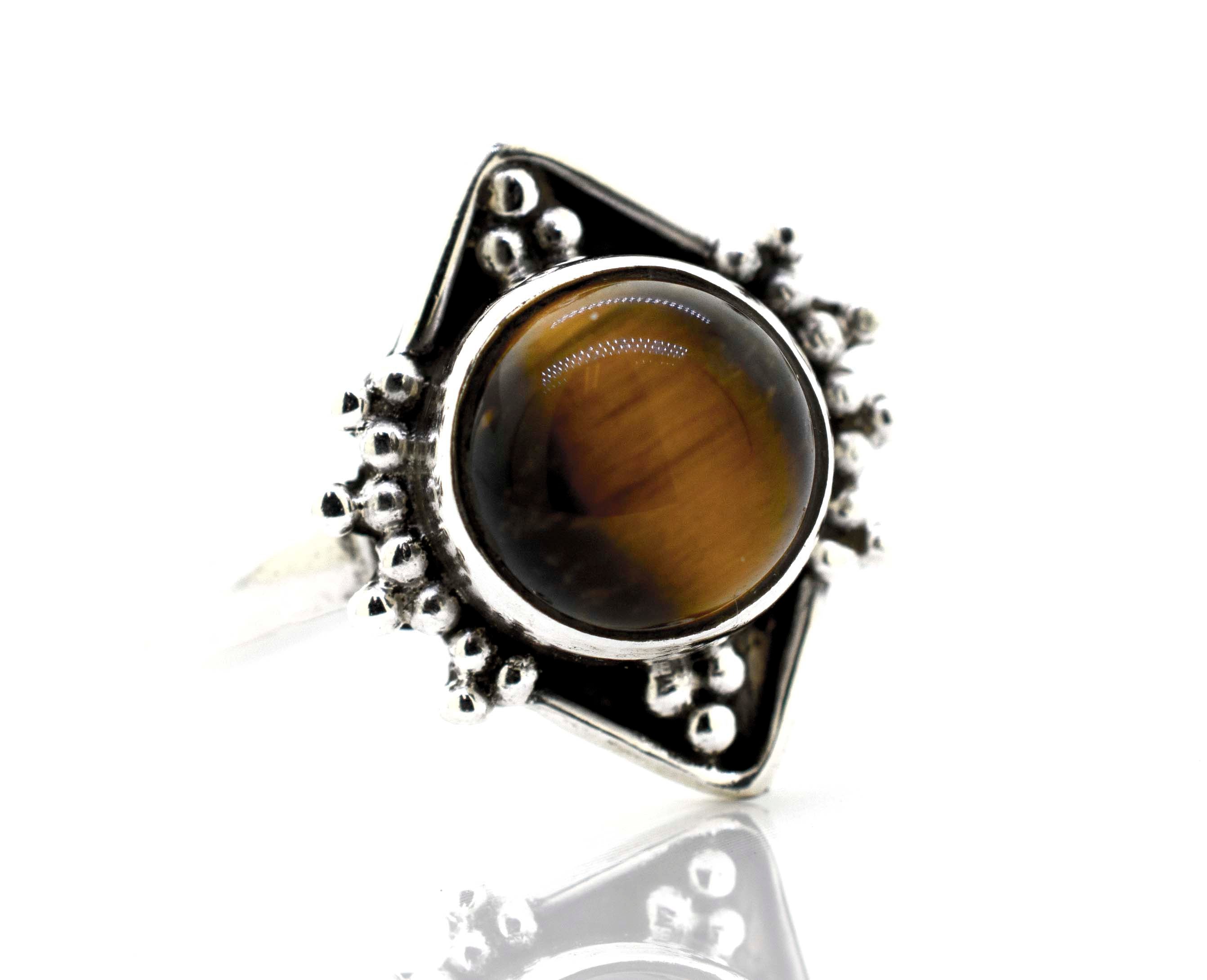 A boho Round Gemstone Ring With Oxidized Diamond Shape Pattern with a tiger eye stone.