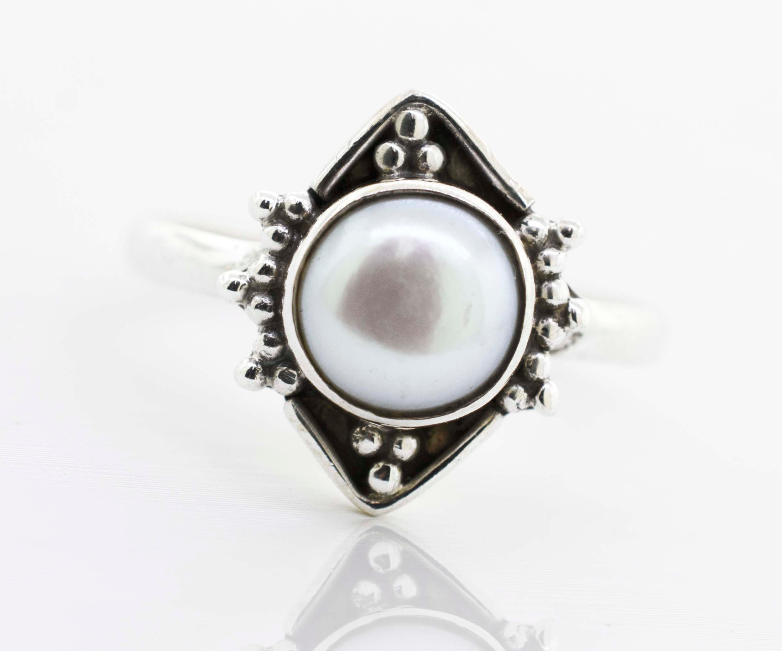 A Super Silver round gemstone ring with oxidized diamond shape pattern in the center.
