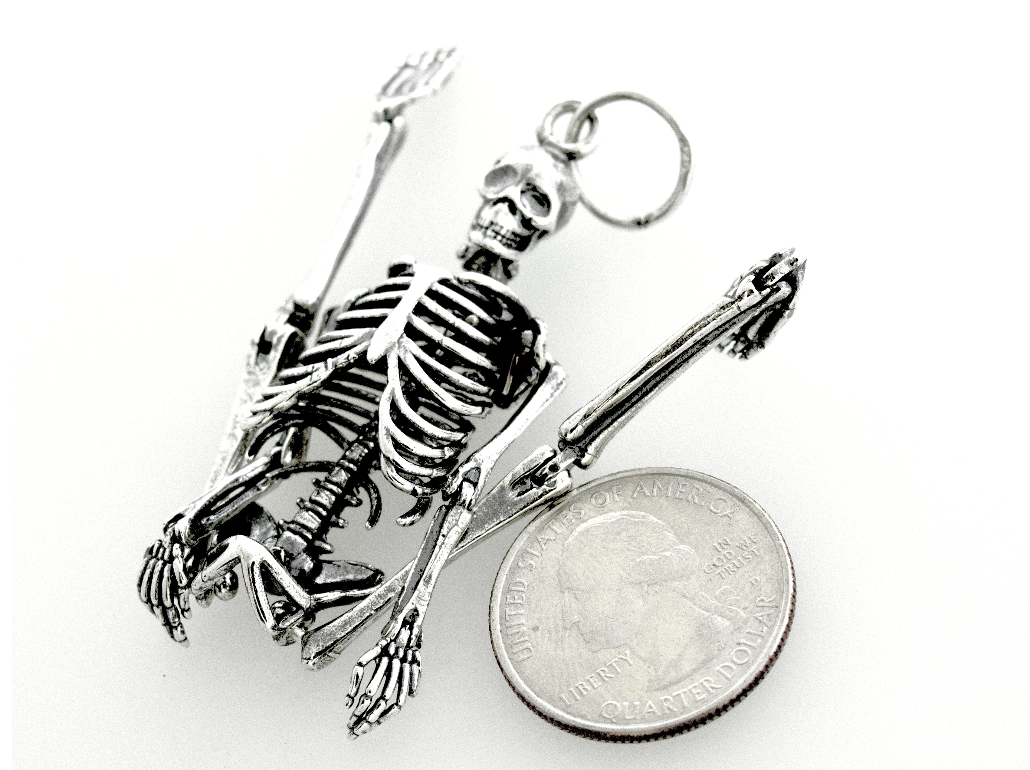 A stylish Super Silver Large Skeleton Pendant paired with a quarter, creating a statement piece.