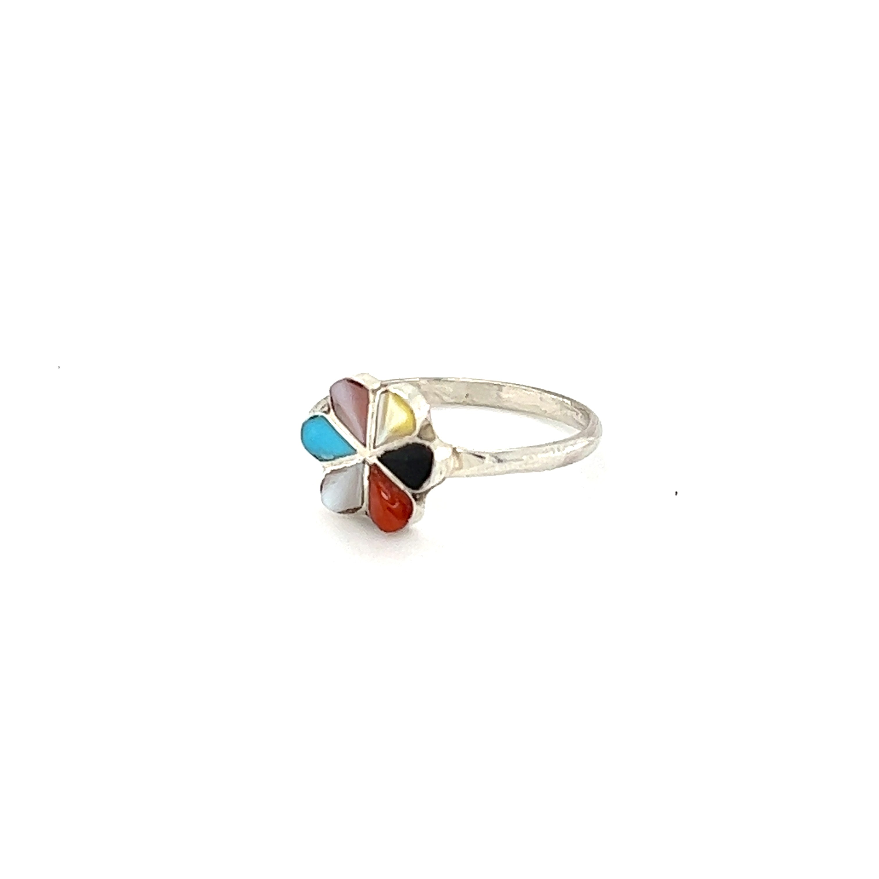 A Zuni Handmade Multi Stone Ring with multi colored stones.