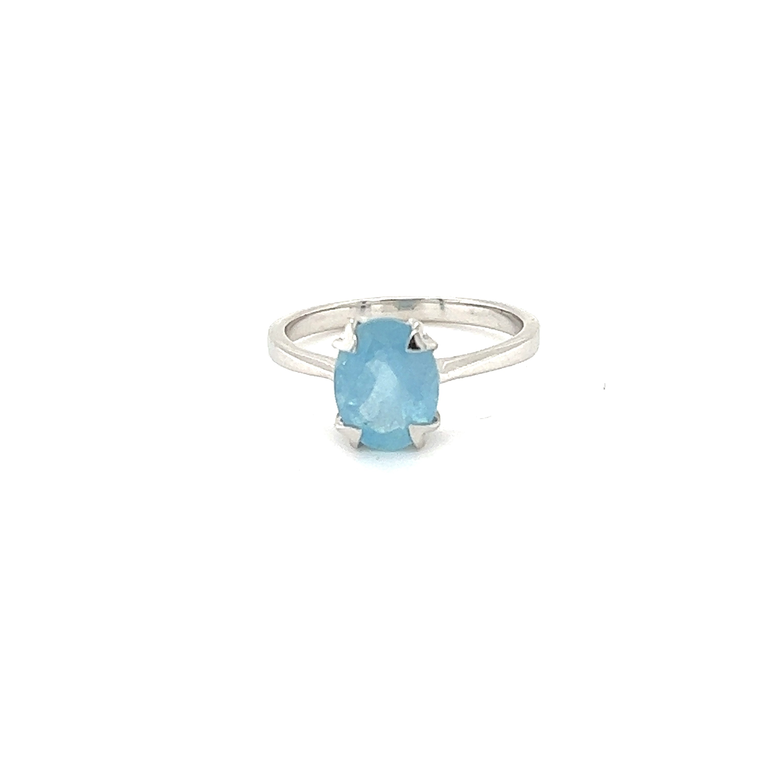 A Super Silver aquamarine ring with a blue topaz on a white background.
