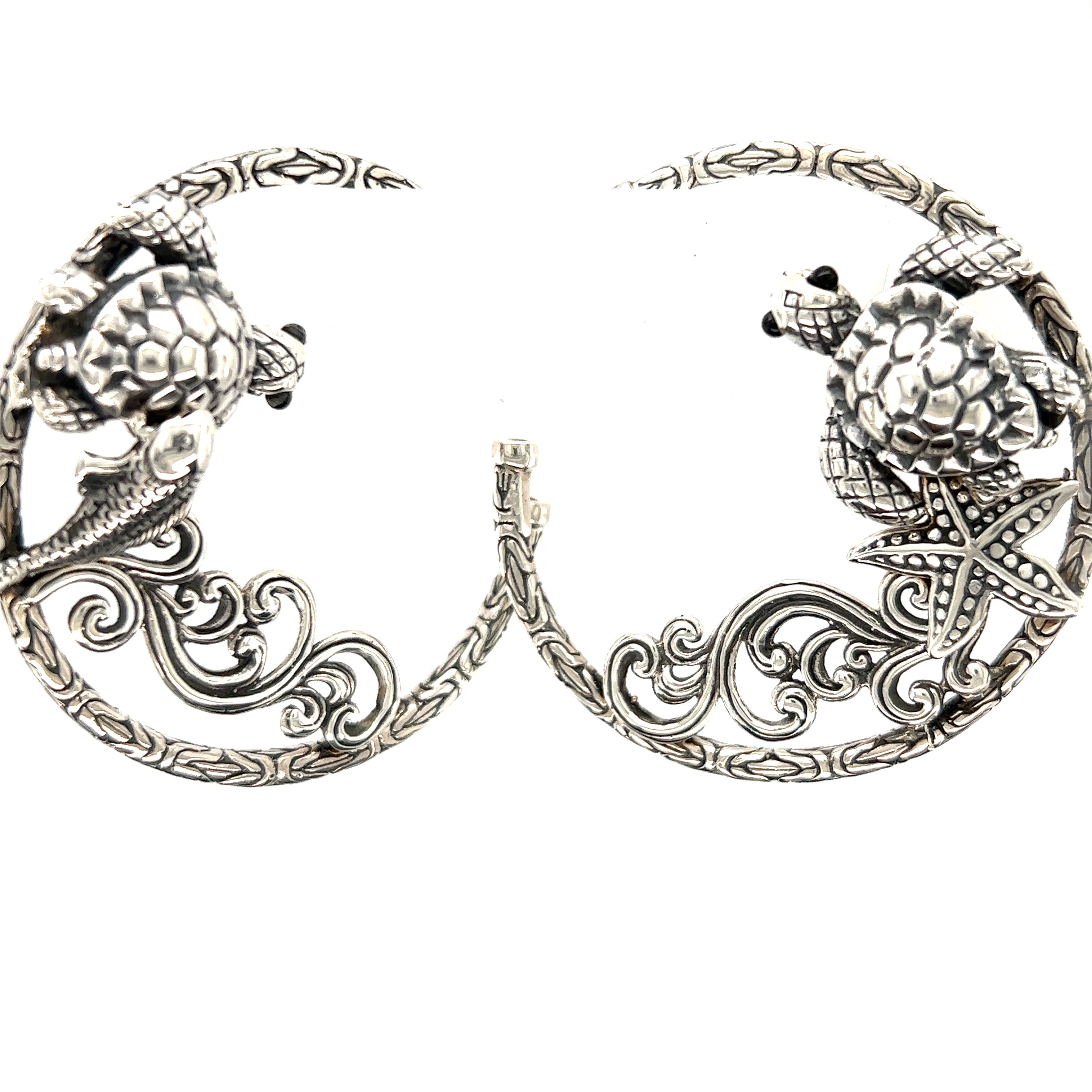A pair of Super Silver Handcrafted Ocean Theme Earrings with an ocean theme featuring turtles.