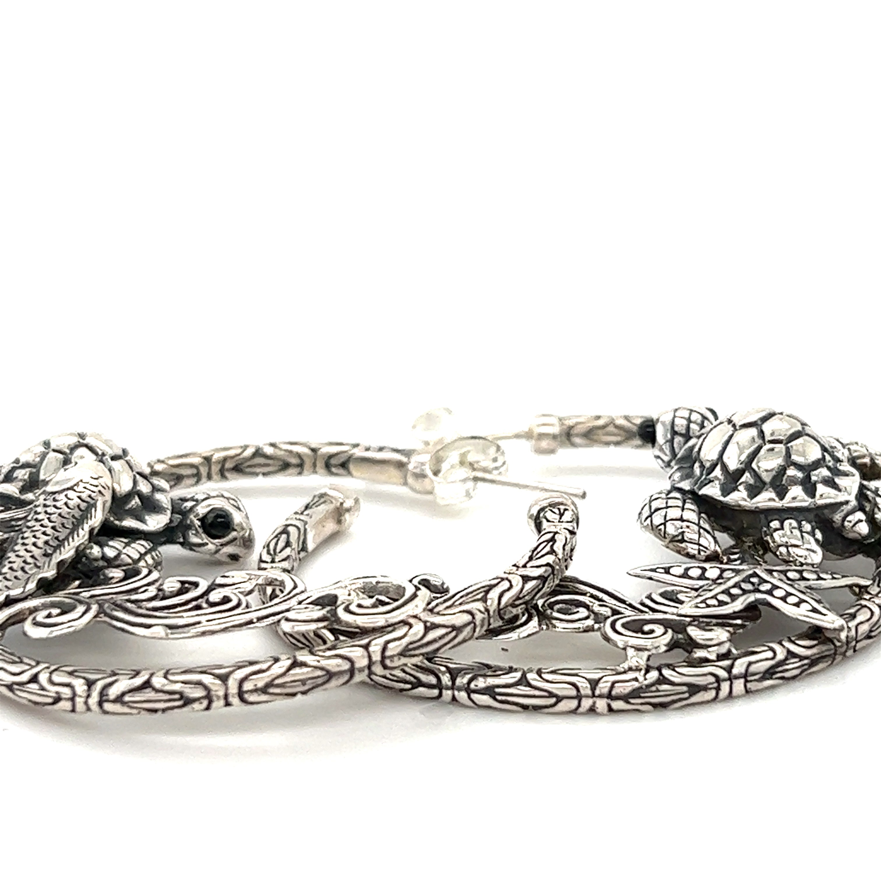 A pair of Super Silver Handcrafted Ocean Theme Earrings, perfect for those who love an ocean-inspired design.