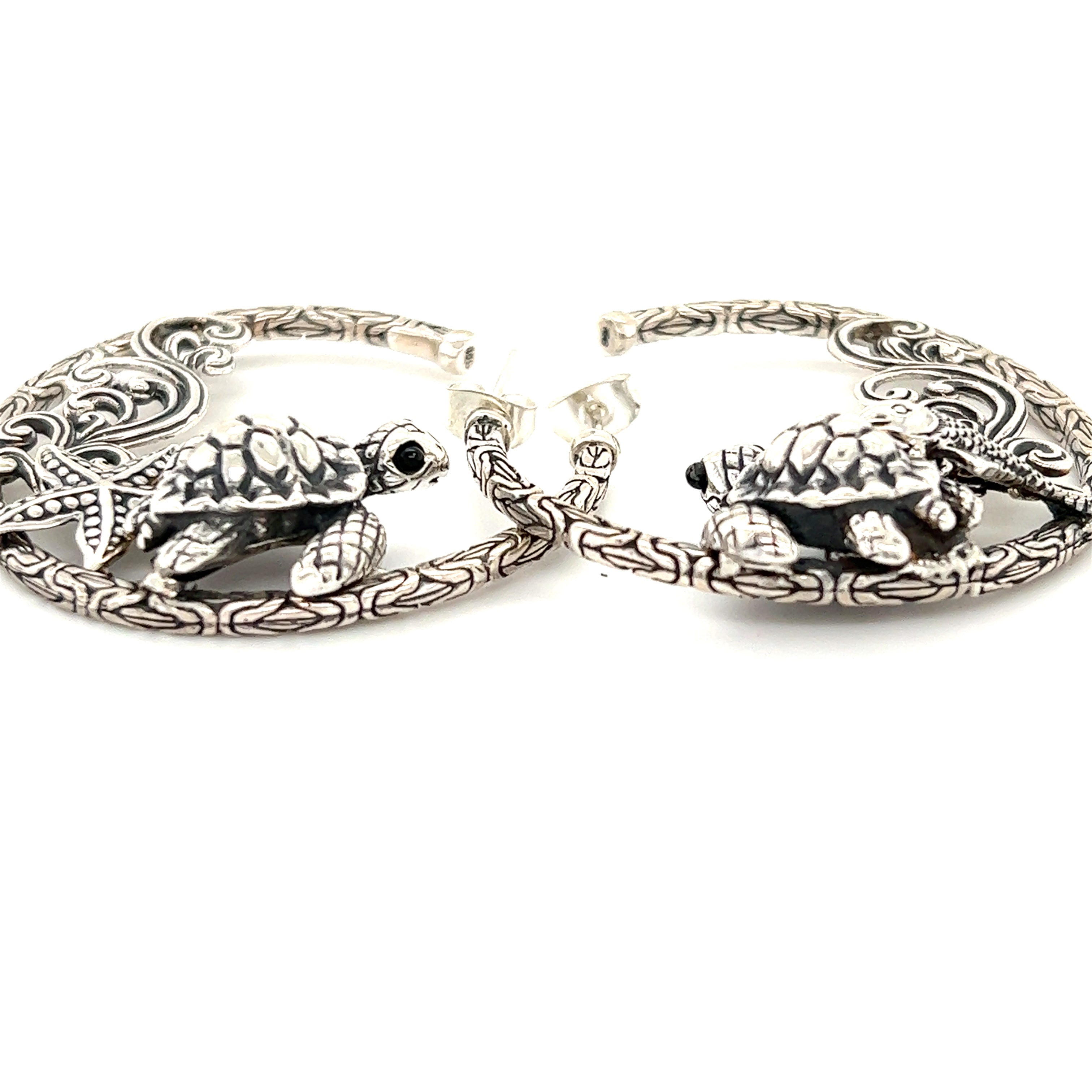 A pair of Super Silver Handcrafted Ocean Theme Earrings, made of .925 silver and adorned with turtles.