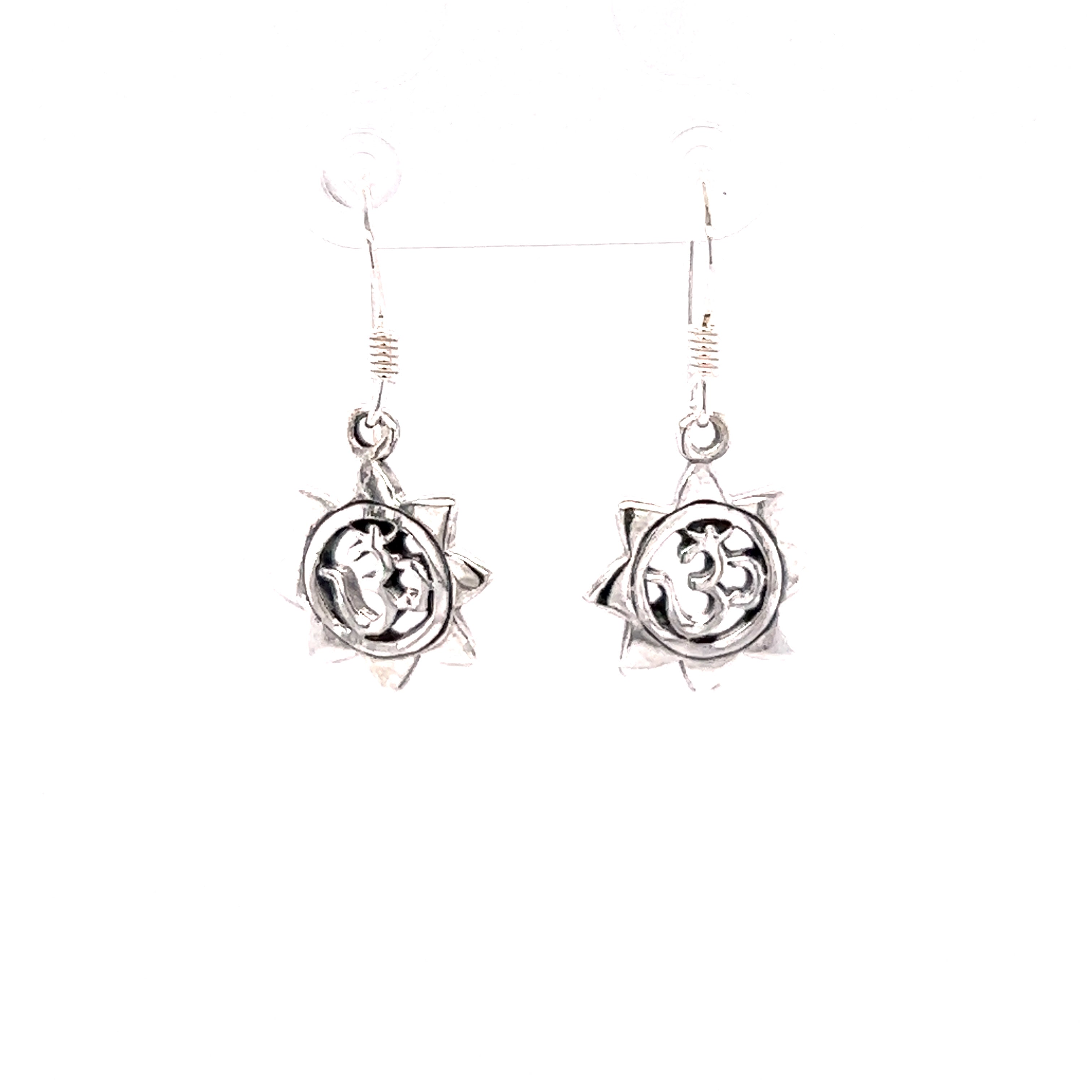 A pair of Super Silver Om With Sun Earrings.