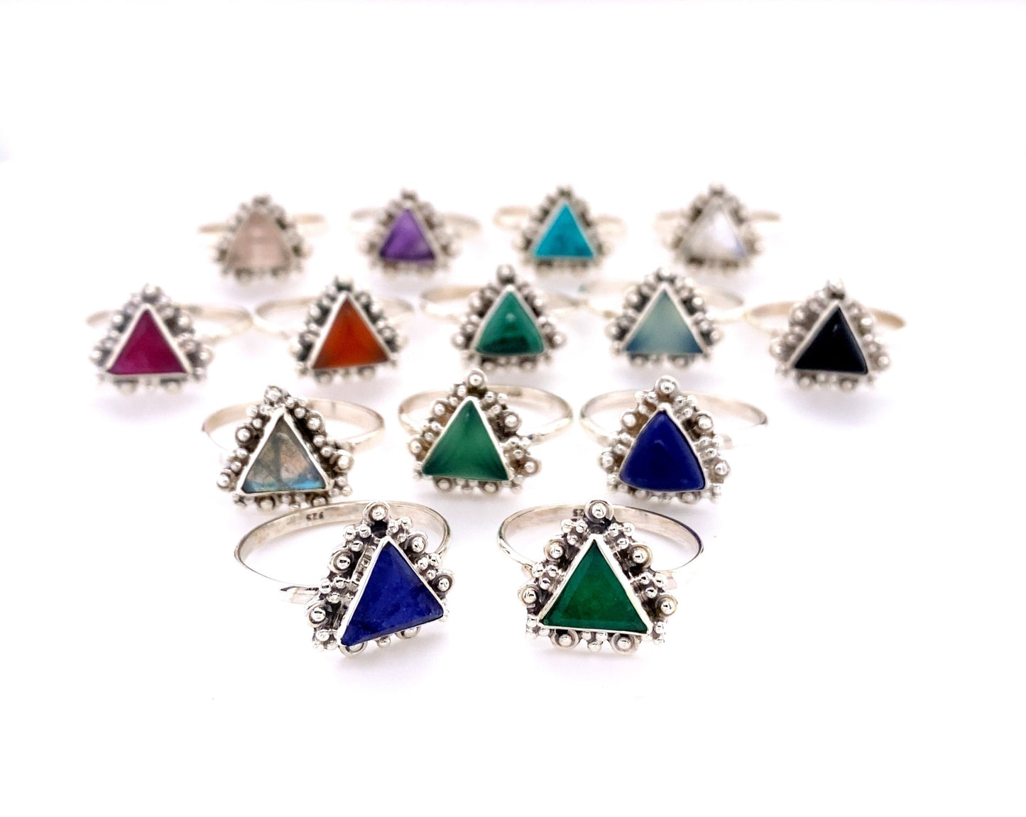 A group of Delicate Gemstone Triangle Rings with different colored stones.