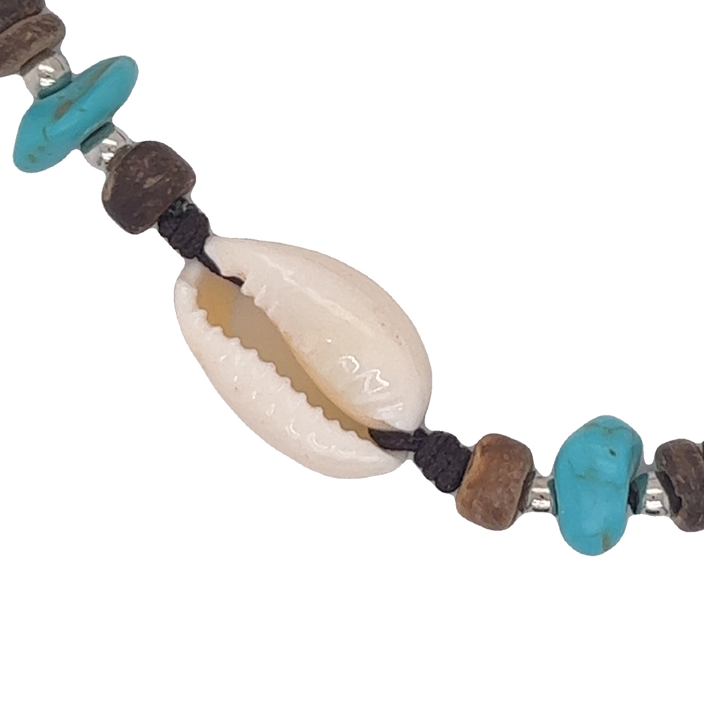 A stretchable band Cowrie Shell Beaded Bracelet with turquoise beads and wooden beads by Super Silver.