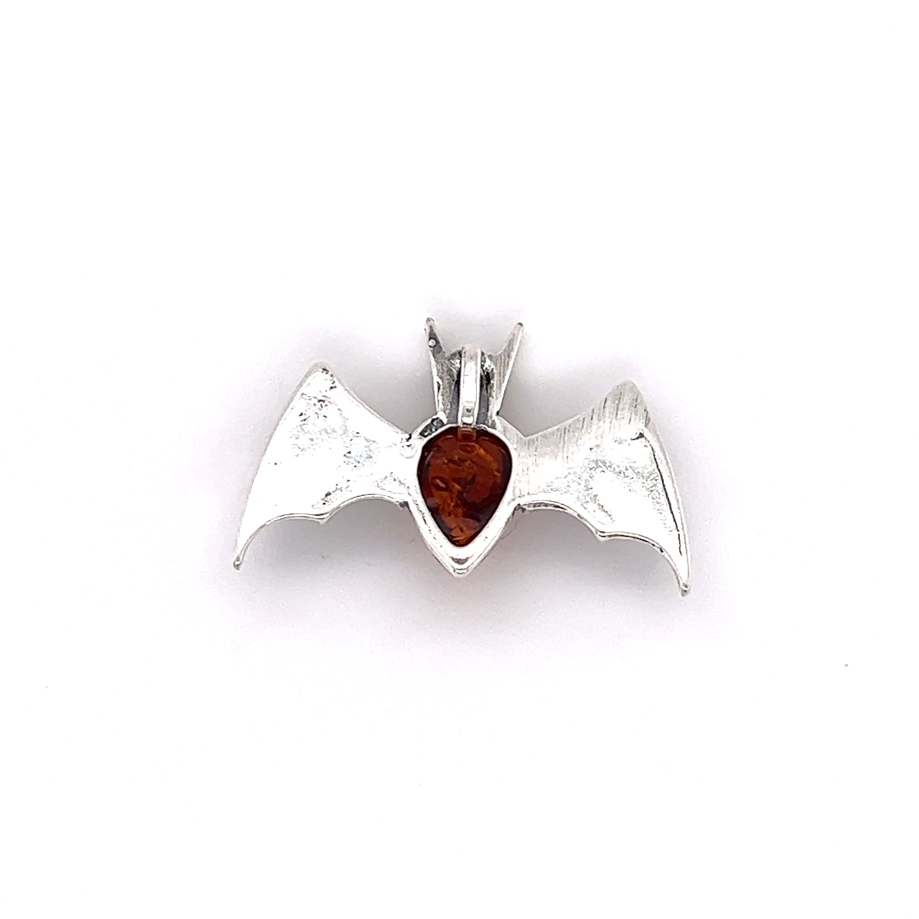 A Haunting Amber Bat Pendant from Super Silver adorned with a stunning Baltic amber stone in deep cognac colors.