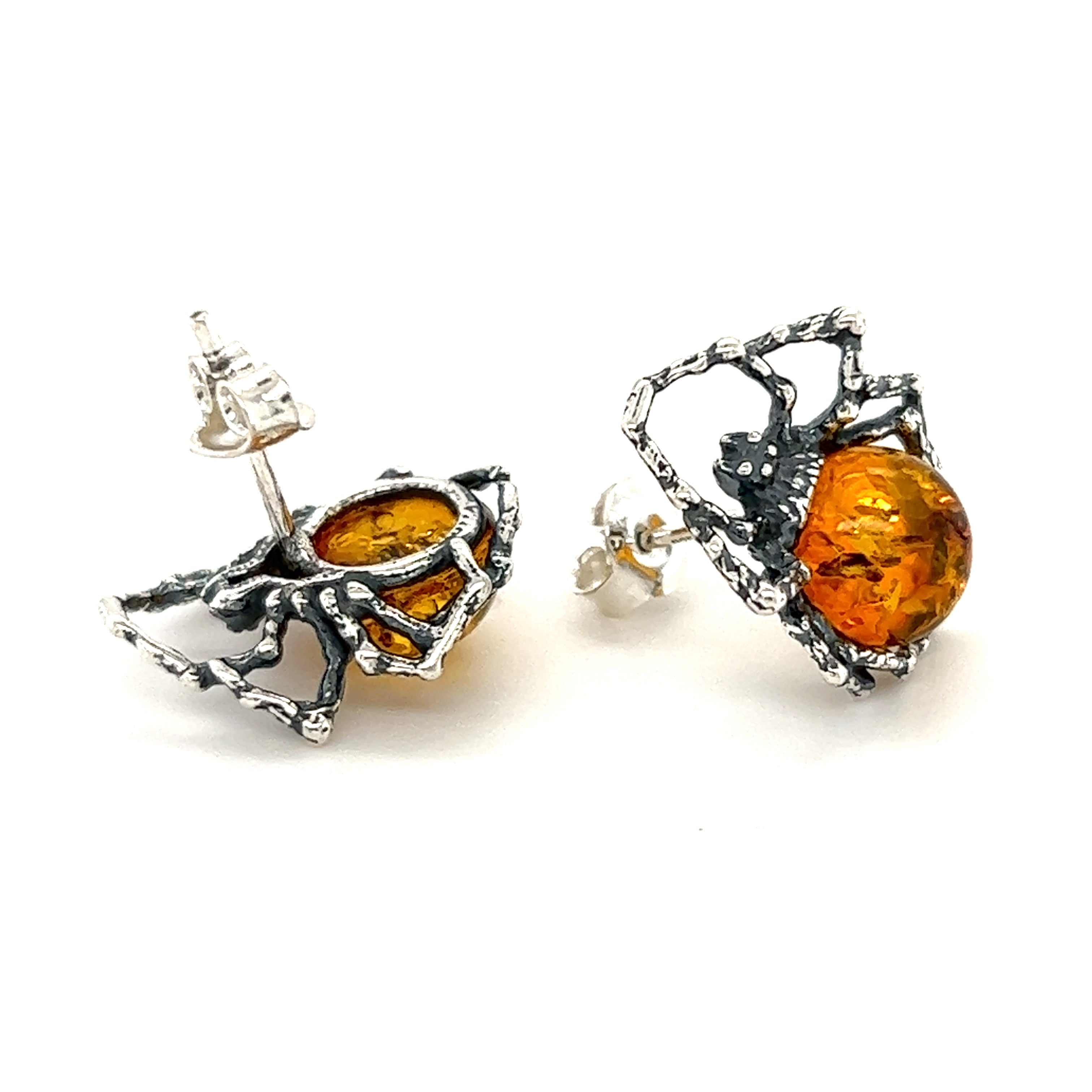 A pair of Eerie Amber Spider stud earrings by Super Silver, perfect for self-empowerment and featuring stunning orange and silver tones.