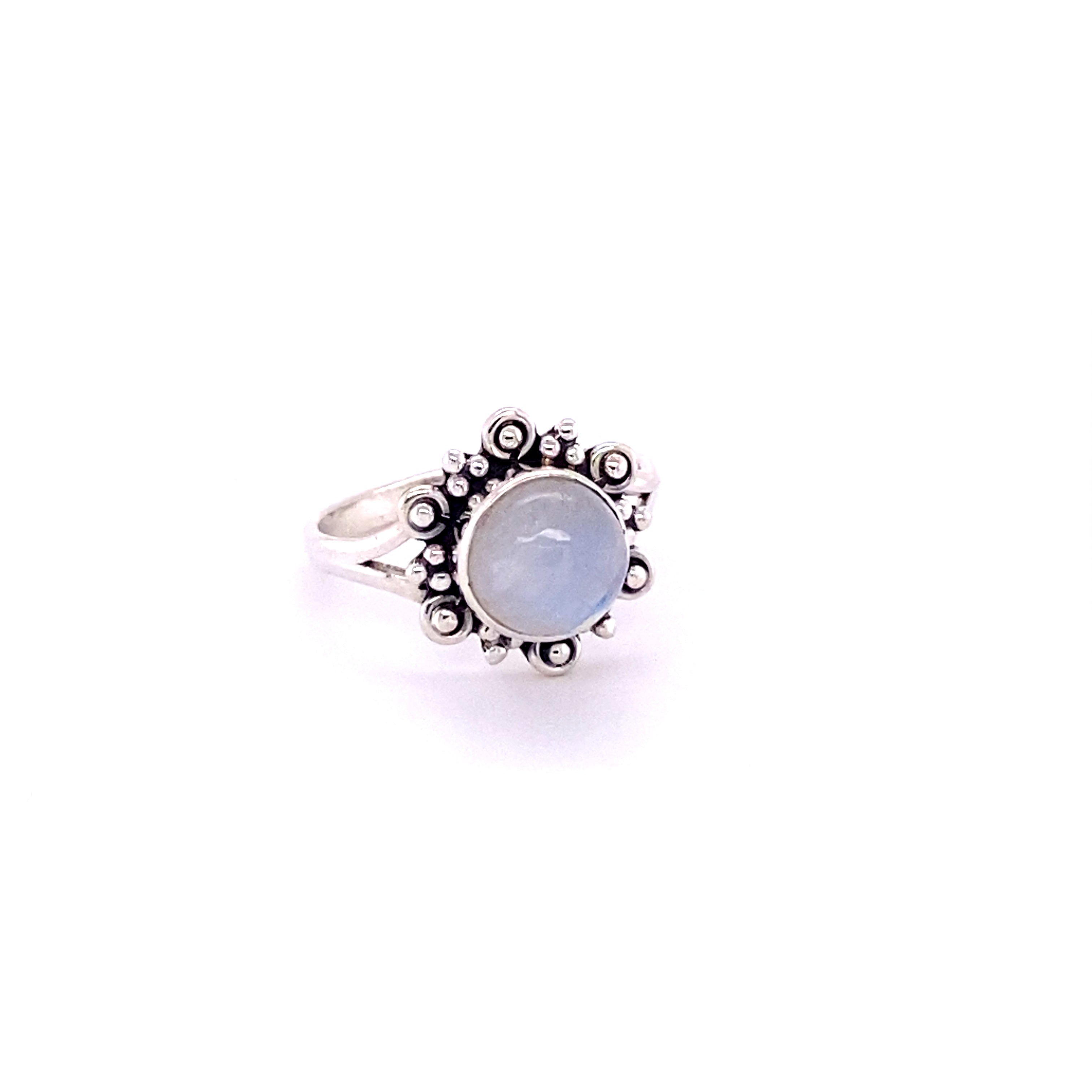 A Beautiful Round Flower Ring with Natural Gemstones with a blue stone in the center.