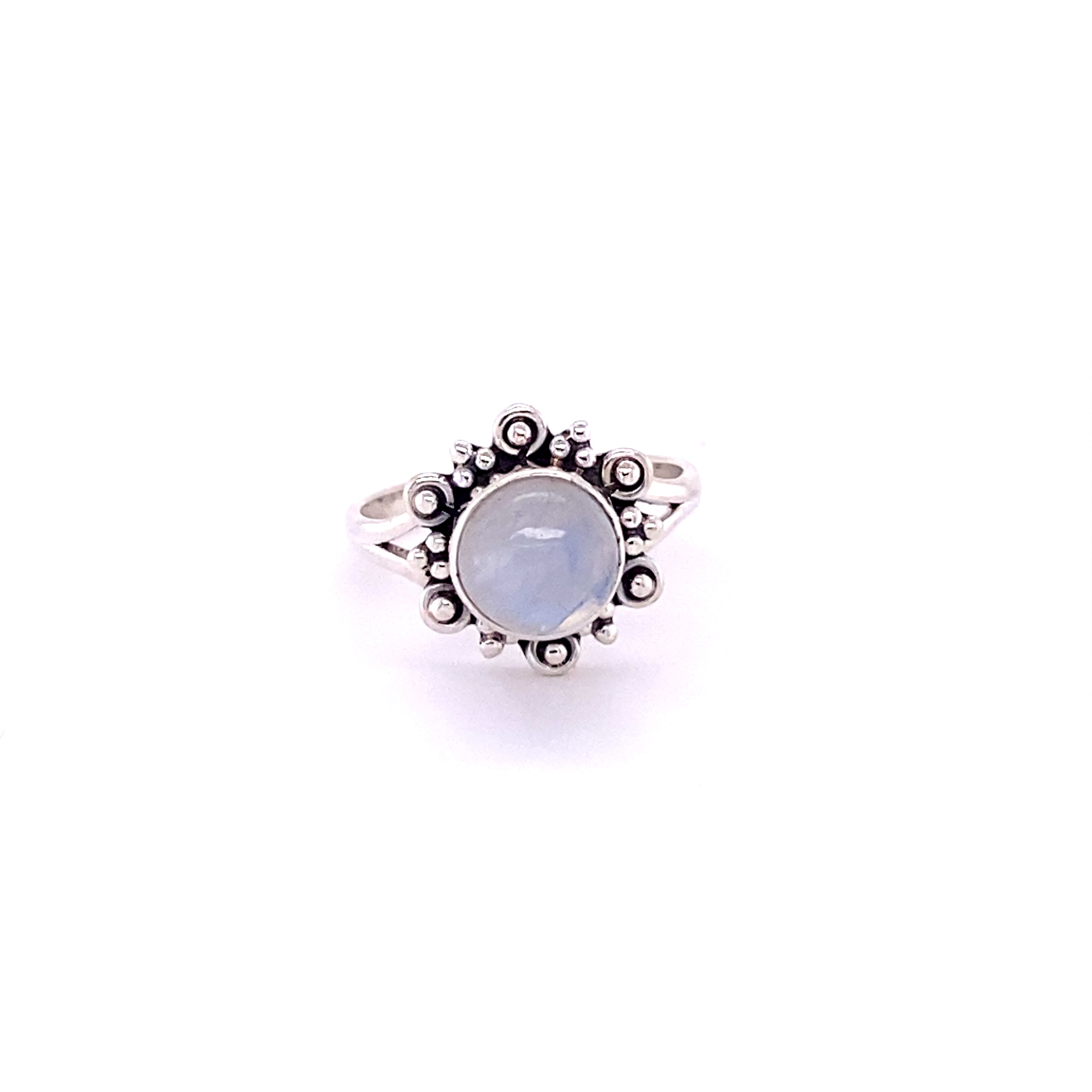 A Beautiful Round Flower Ring with Natural Gemstones with a blue stone in the center.