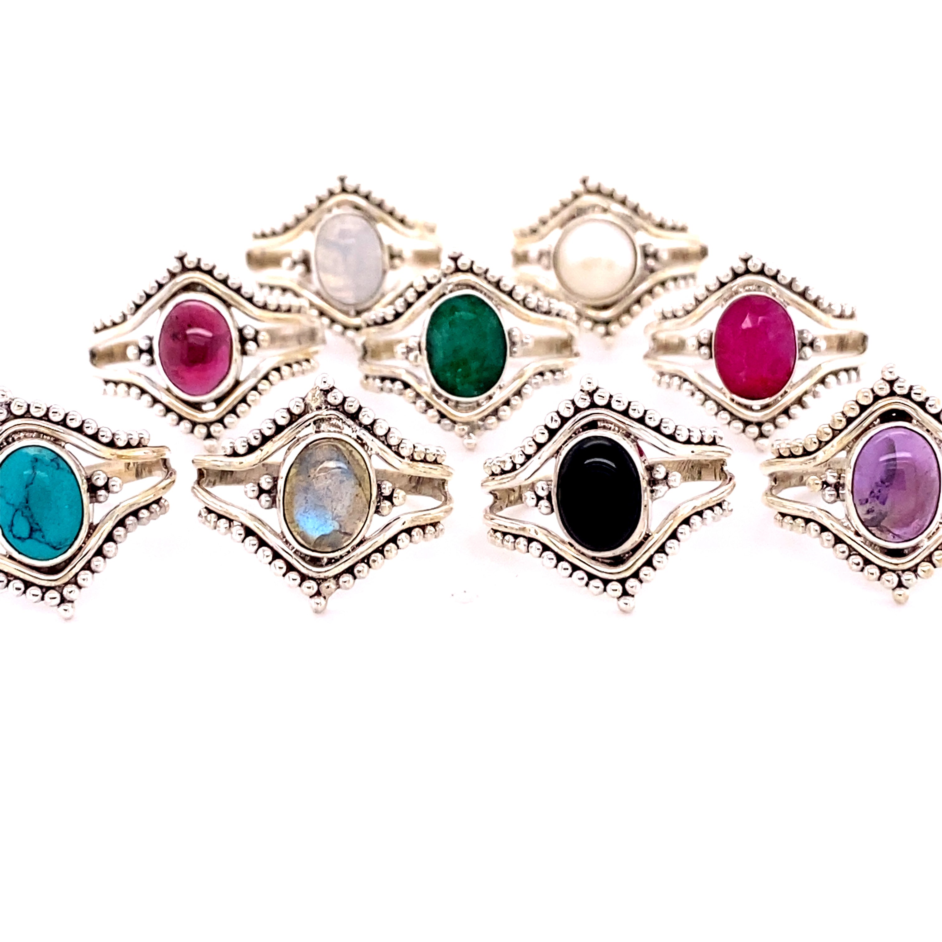 A Double Chevron Gemstone Ring with Ball Design adorned with different colored stones.