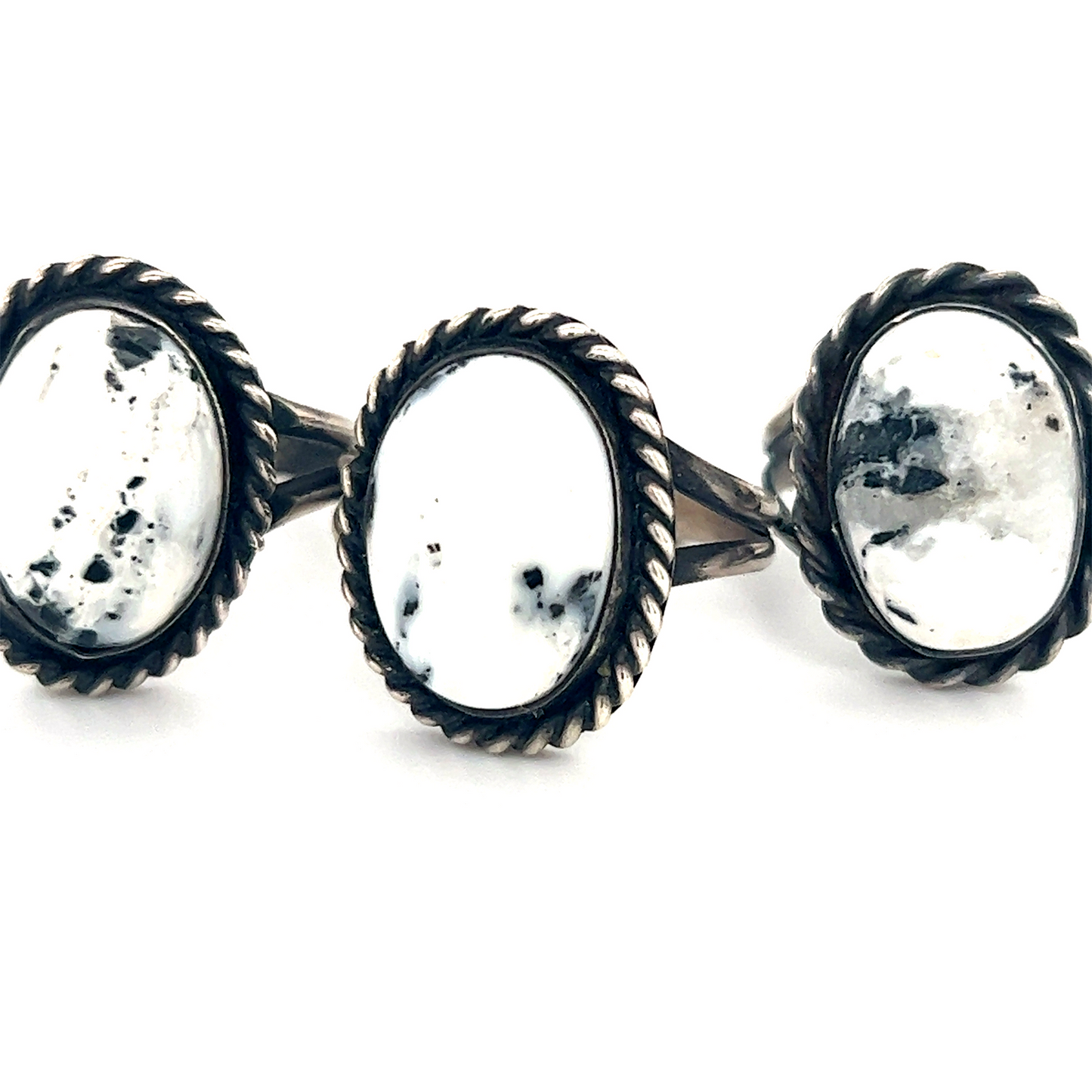 Three native inspired Unique White Buffalo Turquoise Rings with a white stone in the middle.
