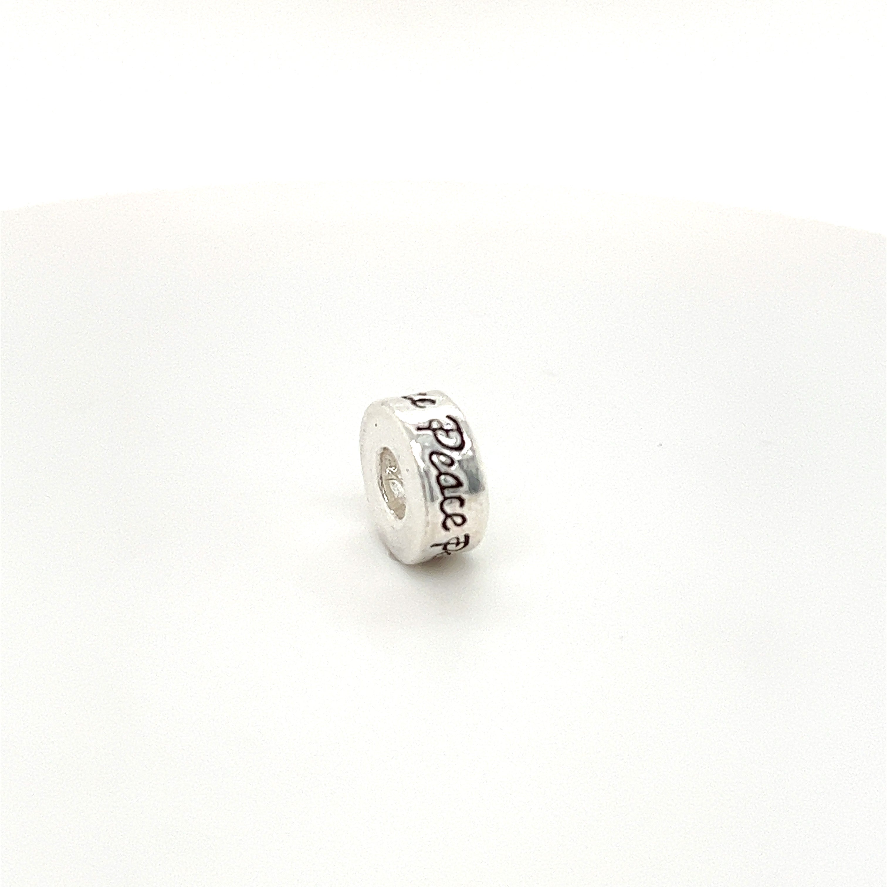 A Super Silver Affirmation Bead Charm with the word 'love' on it.