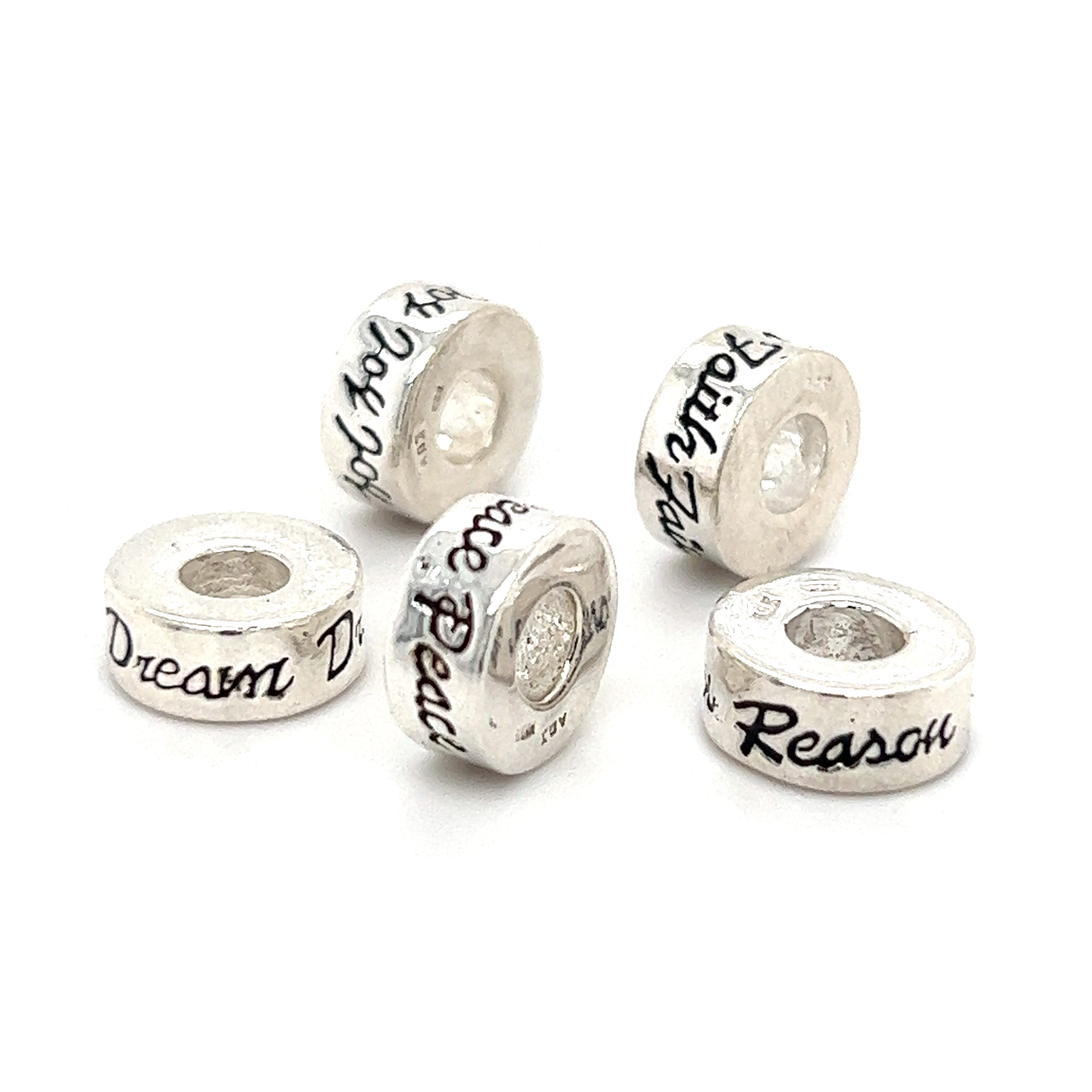 Four Super Silver Affirmation Bead Charms with the words 'dream' and 'reason'.