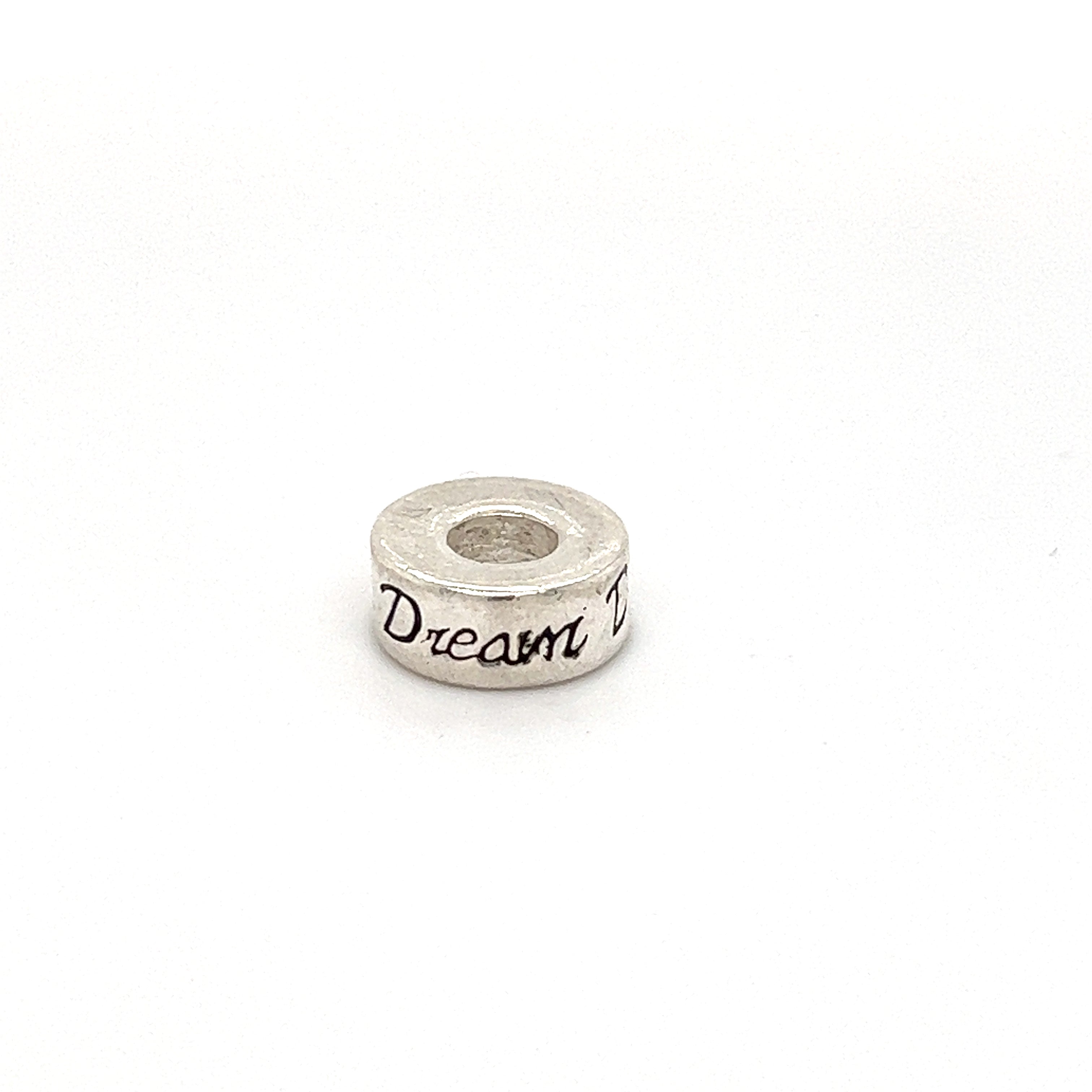 A Super Silver Affirmation Bead Charm with the word dream on it.