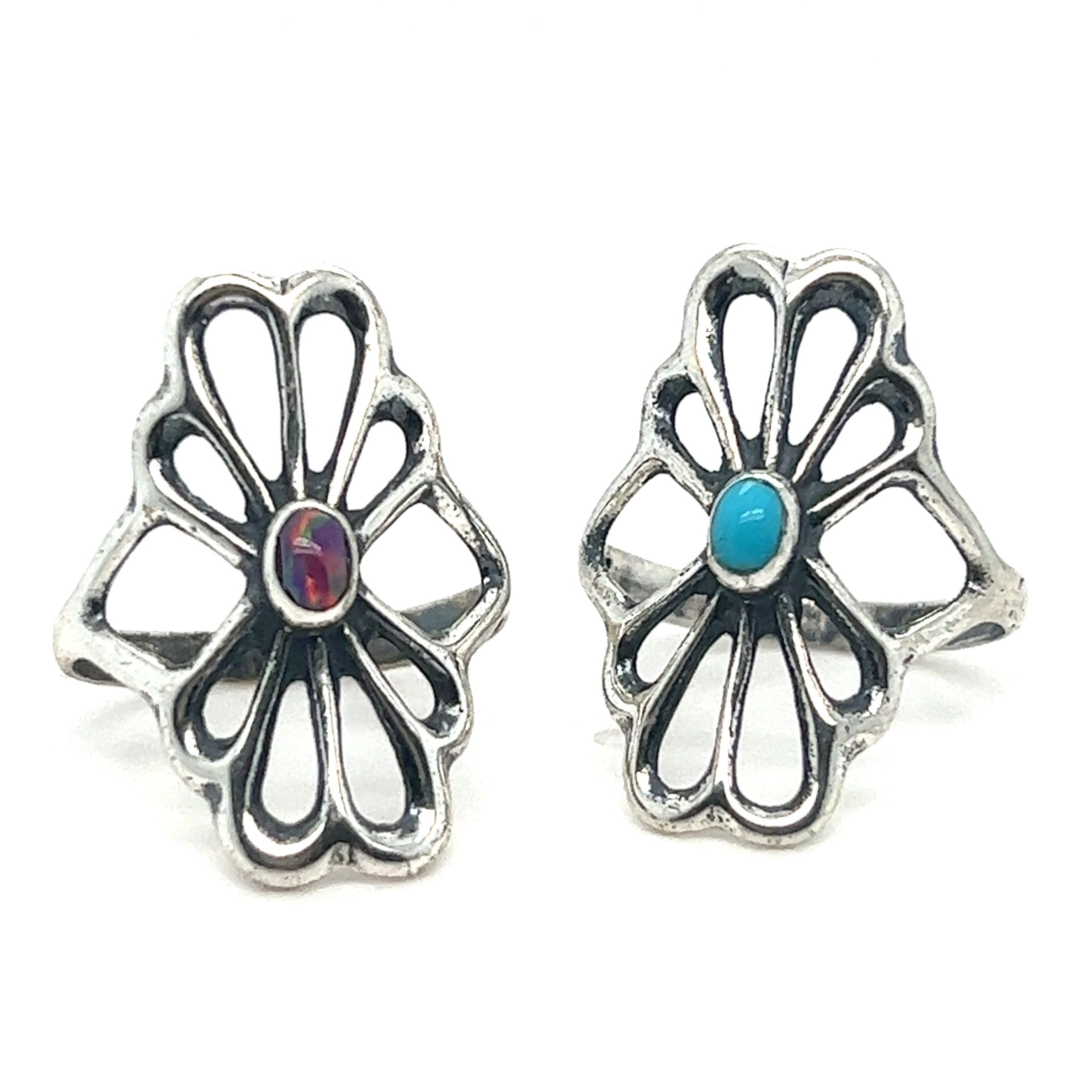 A pair of handcrafted Super Silver American Made Flower Rings with oval turquoise stones.