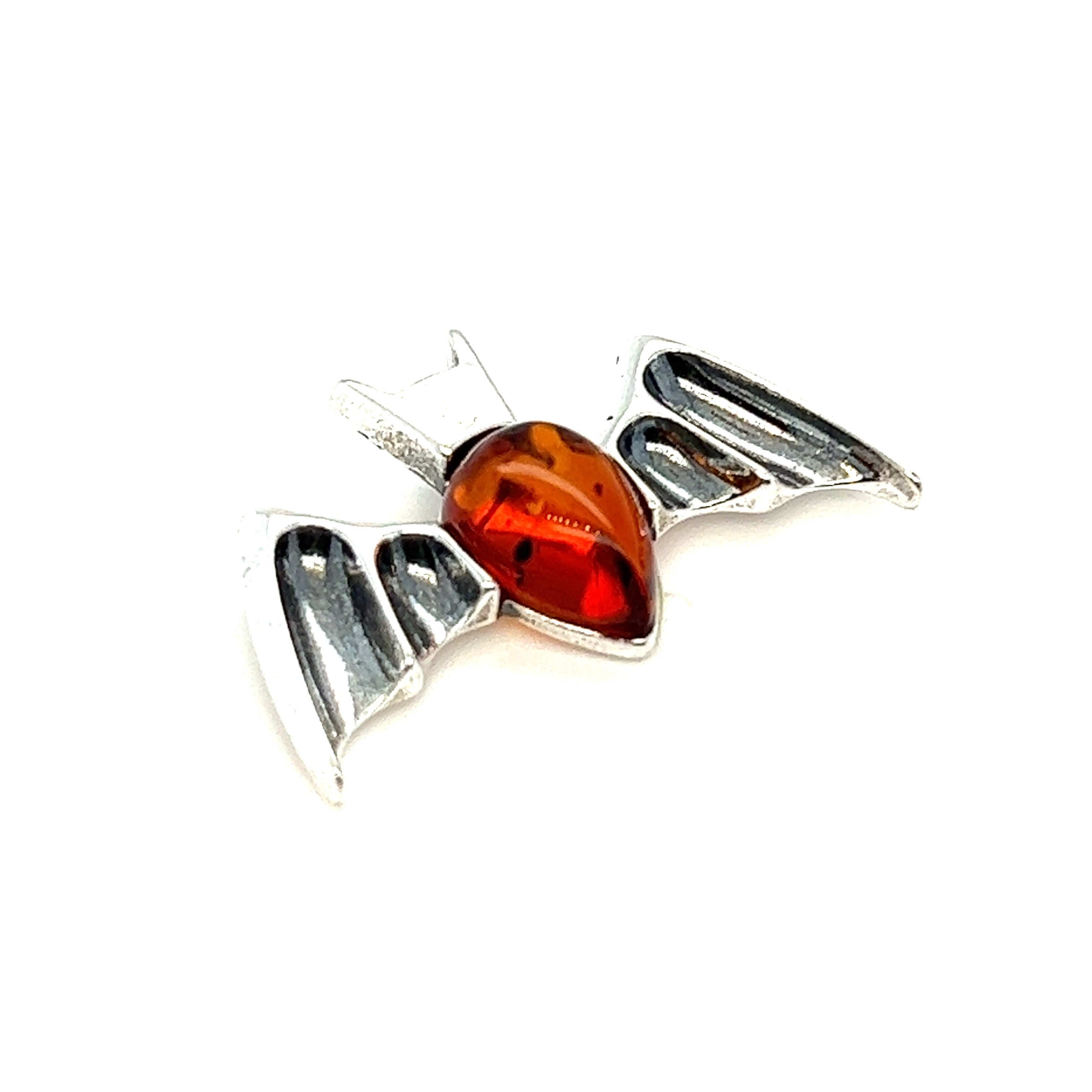 A Super Silver Haunting Amber Bat Pendant adorned with a Baltic amber stone in a rich cognac color.