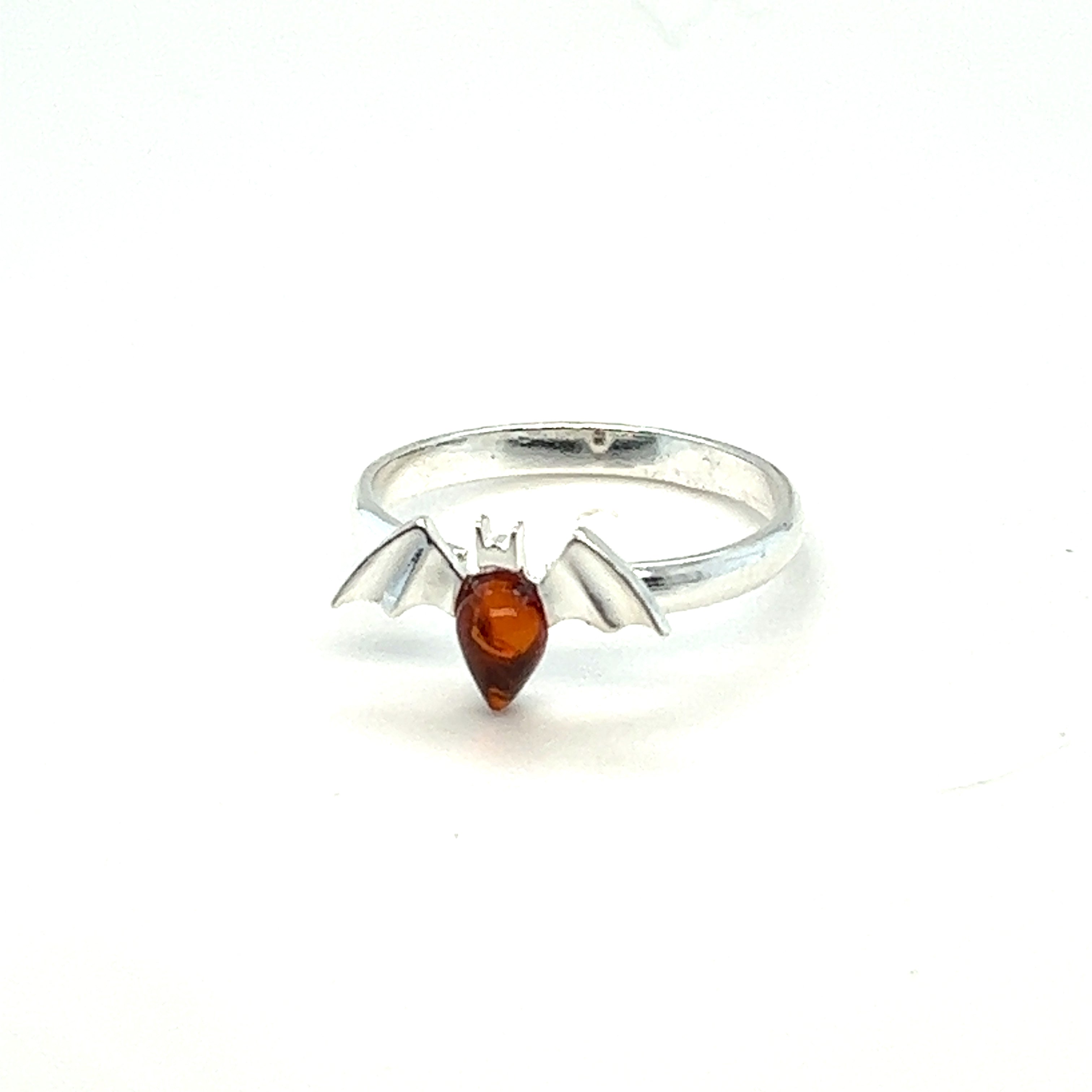 A shiny silver Baltic Amber Bat Ring adorned with a meticulously crafted bat design, perfect for lovers of Gothic jewelry or those seeking a unique accessory to showcase their fascination with bats. (by Super Silver)