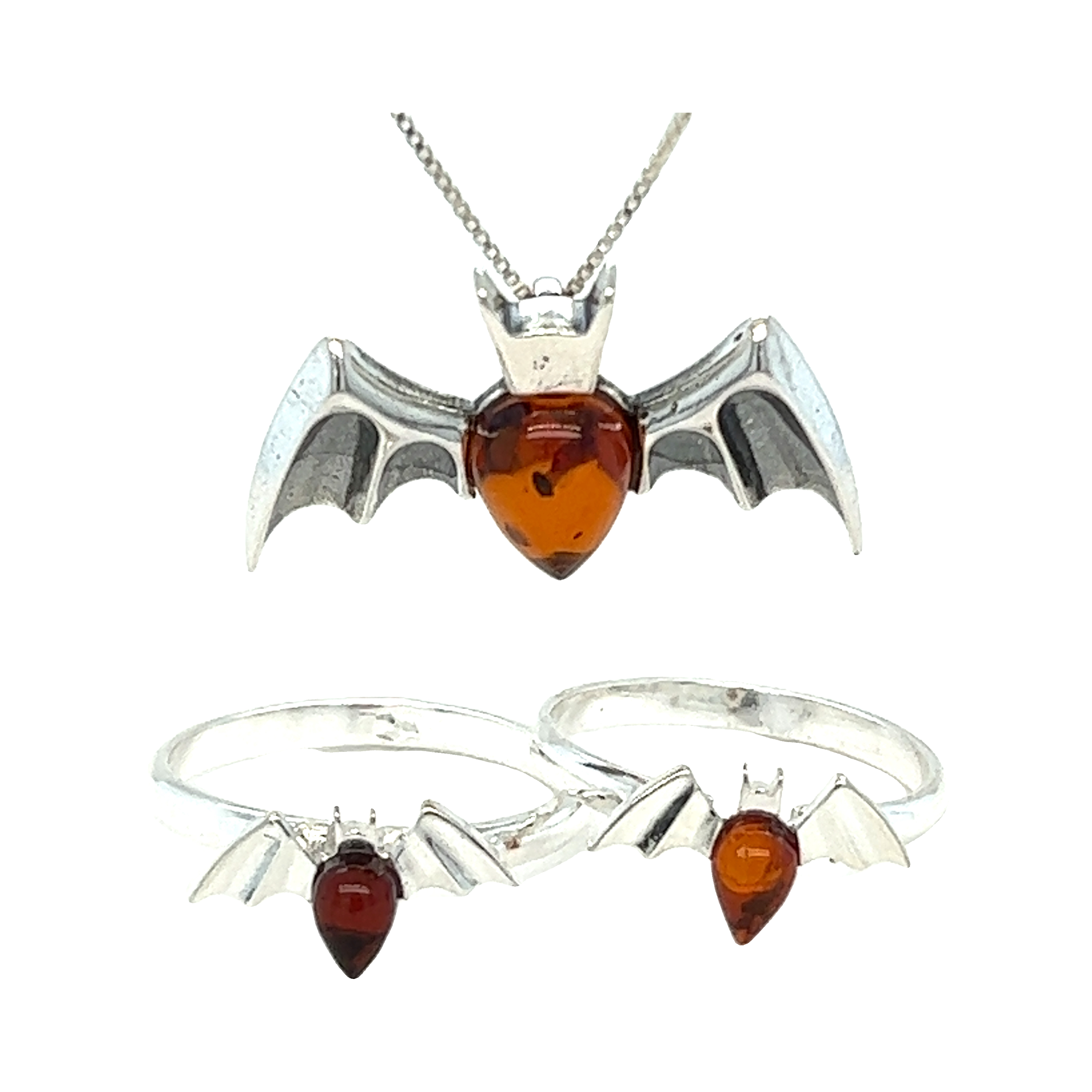 A stunning set of Haunting Amber Bat Pendant earrings, necklace, and ring made with exquisite Baltic amber in rich cognac colors by Super Silver.