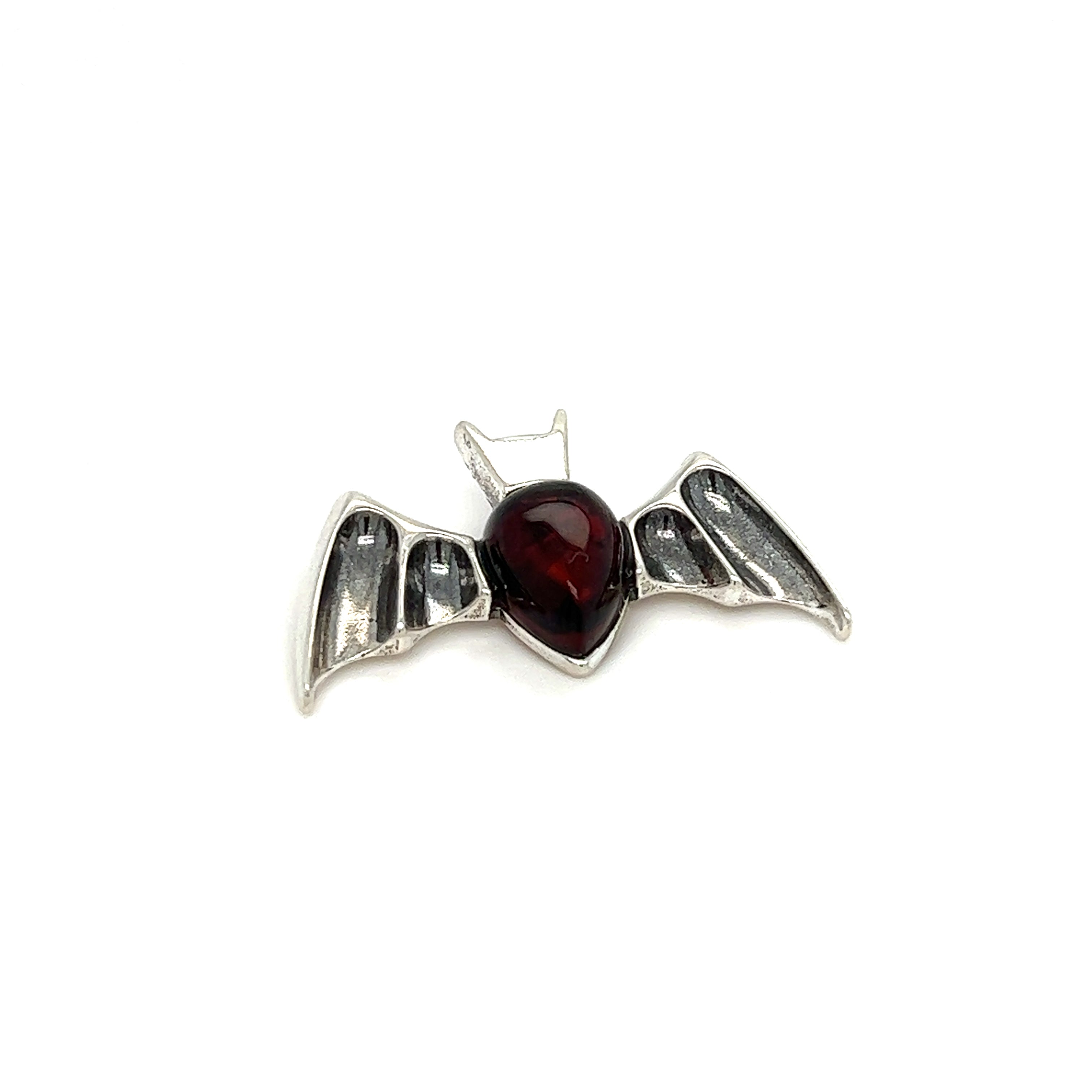 A Super Silver Haunting Amber Bat Pendant with a red Baltic amber stone.