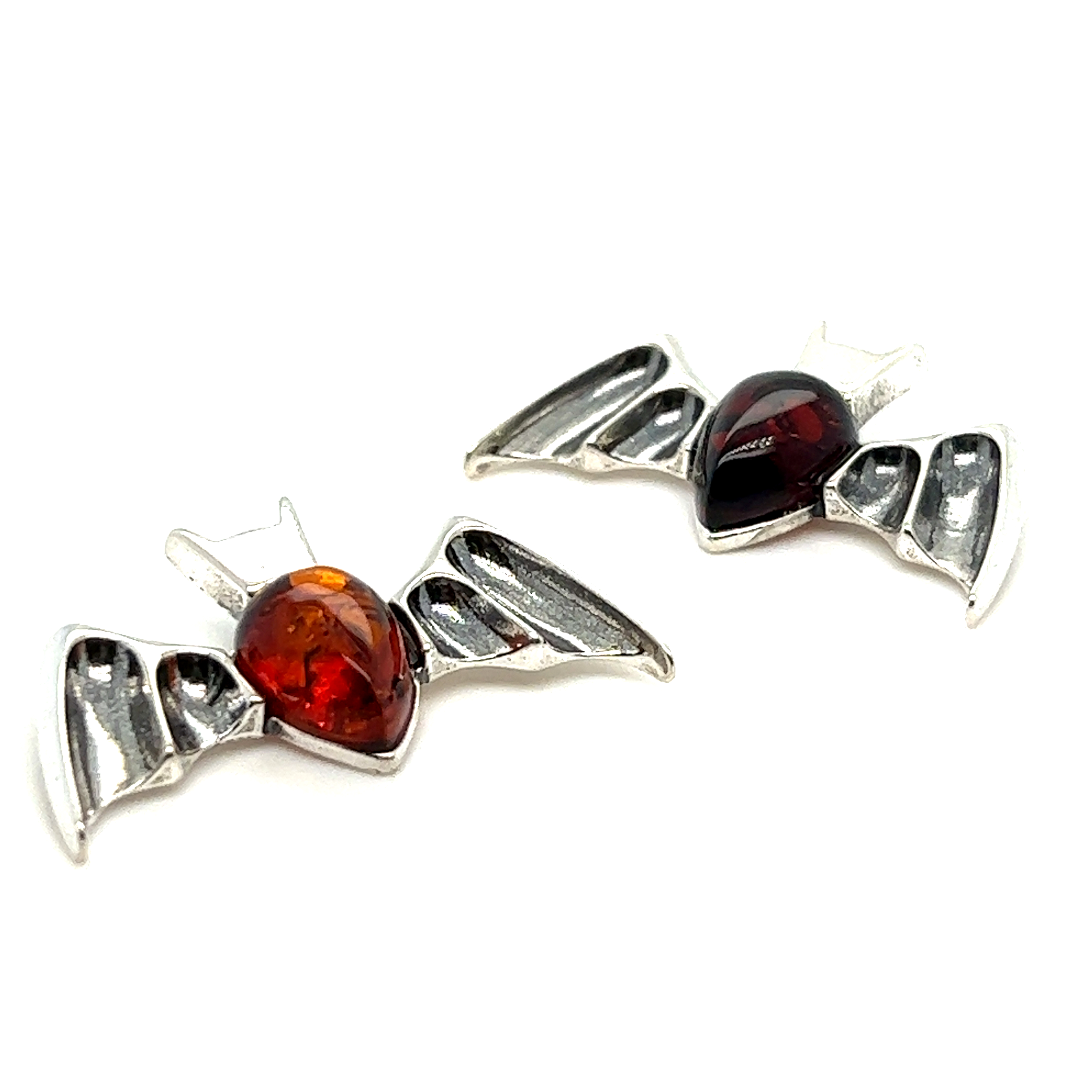 A pair of Haunting Amber Bat Pendant earrings from Super Silver, showcasing the stunning cognac colors.